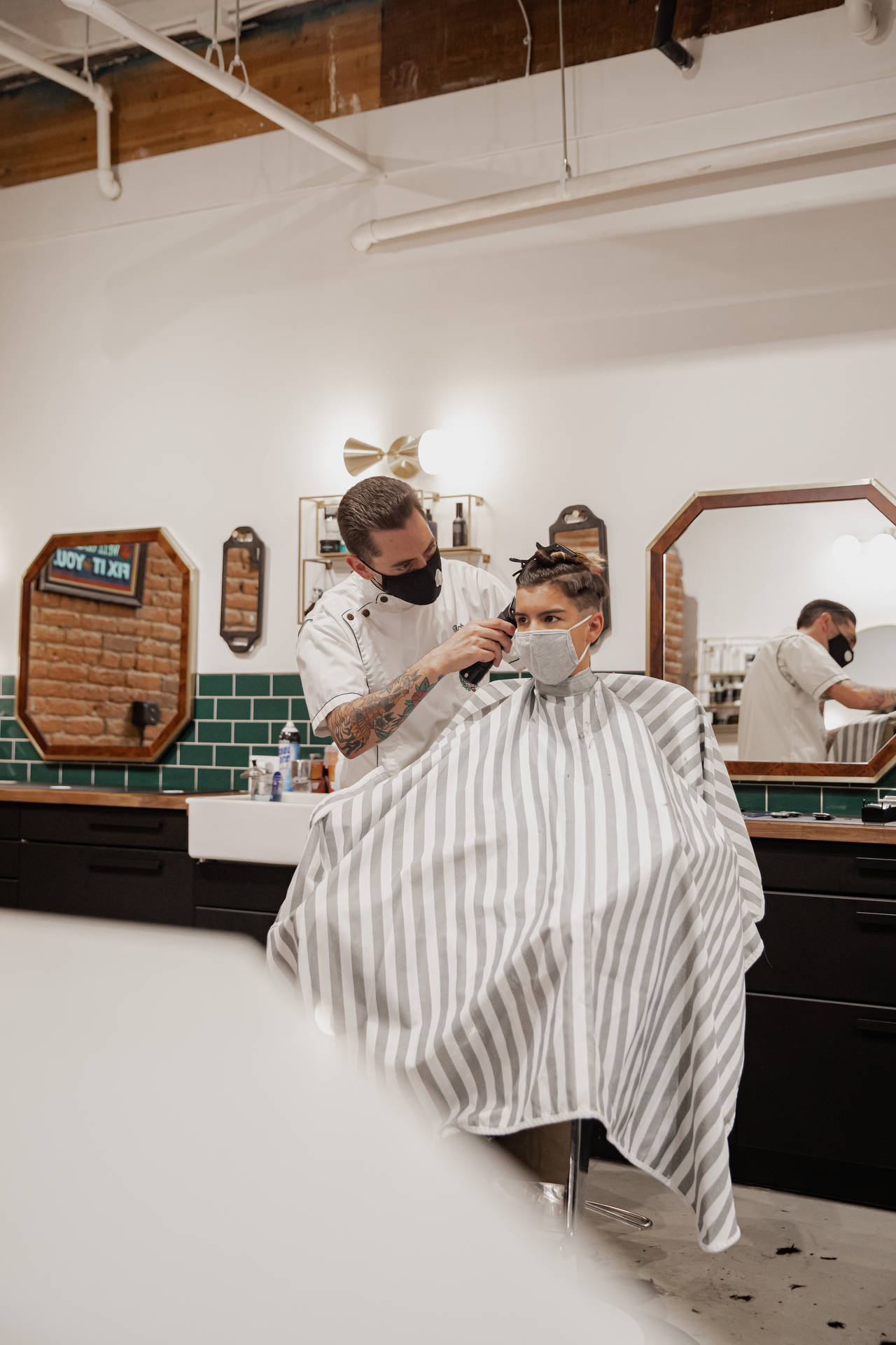 Barber Doing Haircut On Client Background