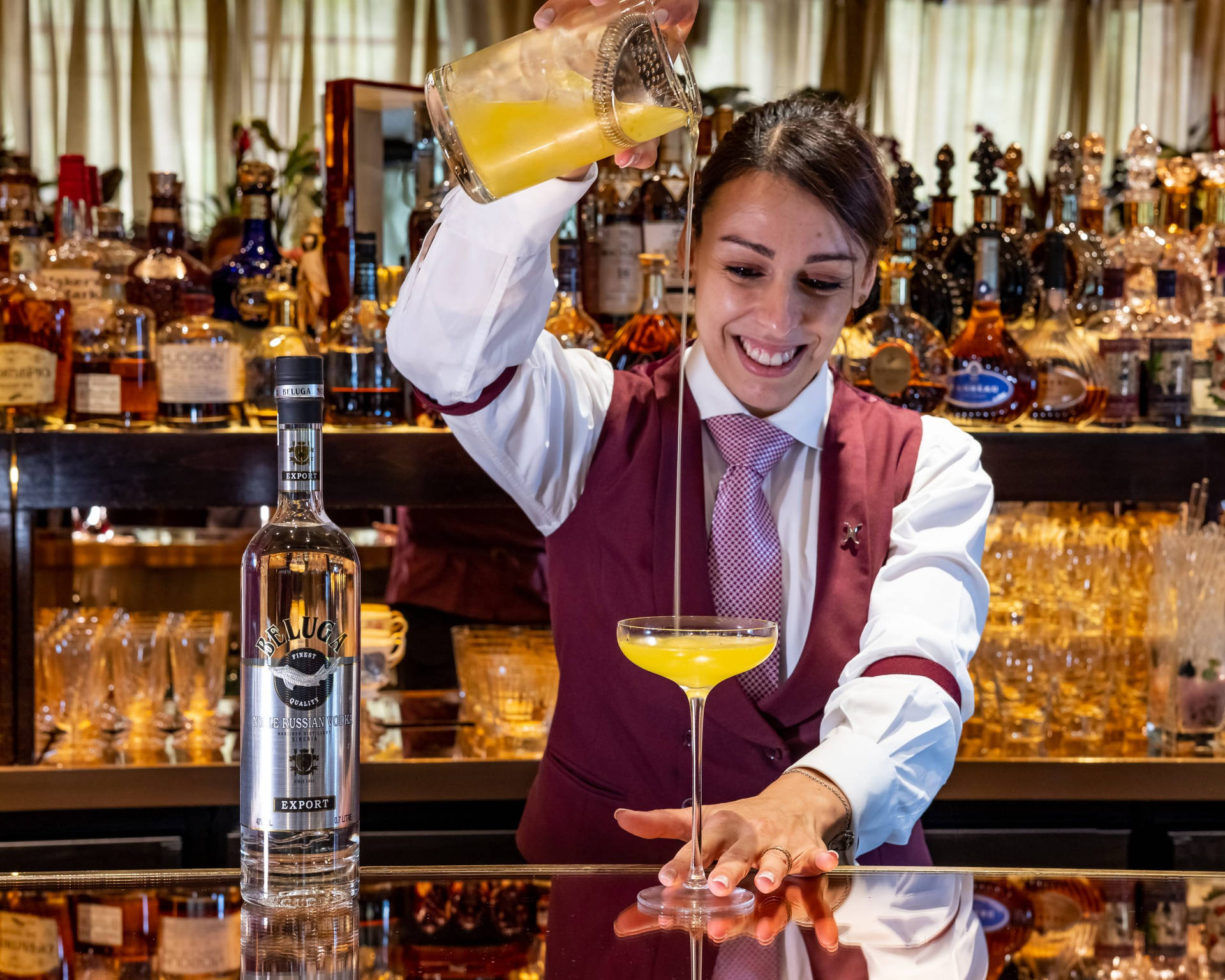 Bartender Mixing Beluga Vodka And Juice Cocktail Background