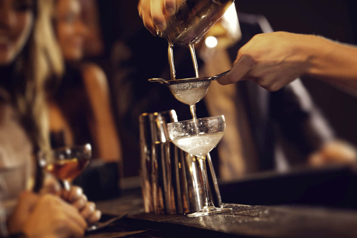 Bartender Pouring Cocktailat Bar Background