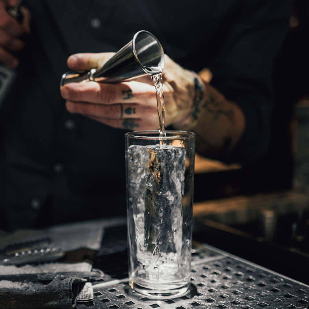 Bartender Pouring Drink Into Glass Background