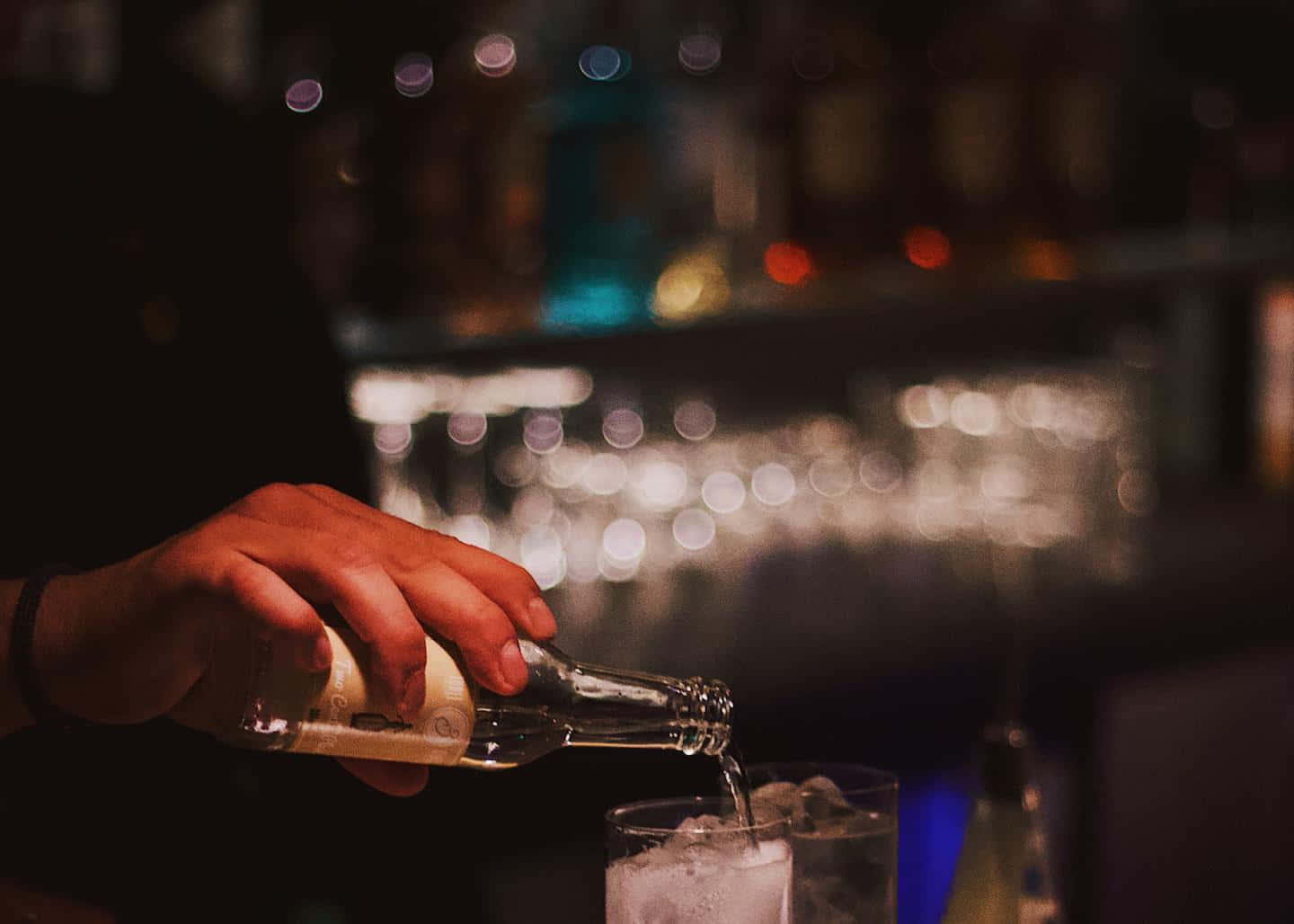 Bartender Pouring Drinkat Bar Background