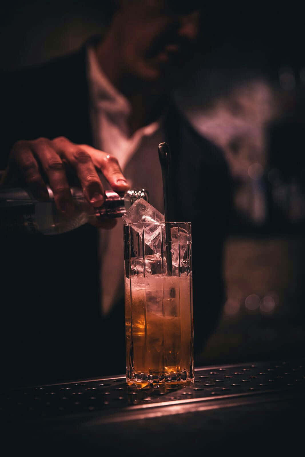 Bartender Pouring Drinkat Bar Background