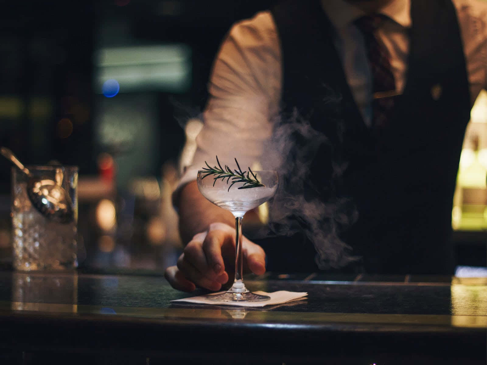 Bartender Serving Smoky Cocktail Background