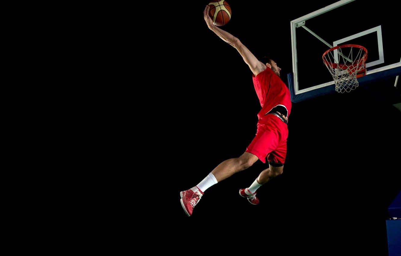 Basketball Athlete Leaps For A Dunk