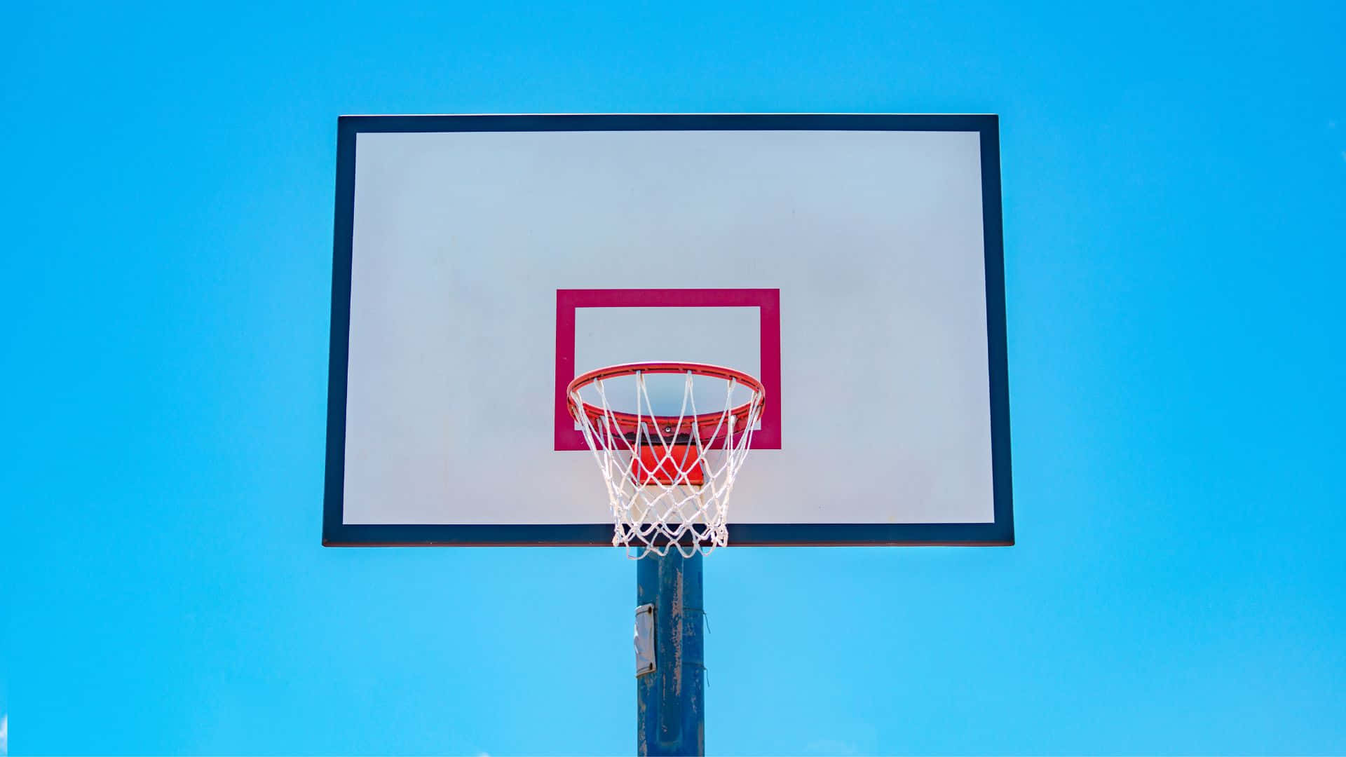 Basketball Hoop Against Blue Sky Background