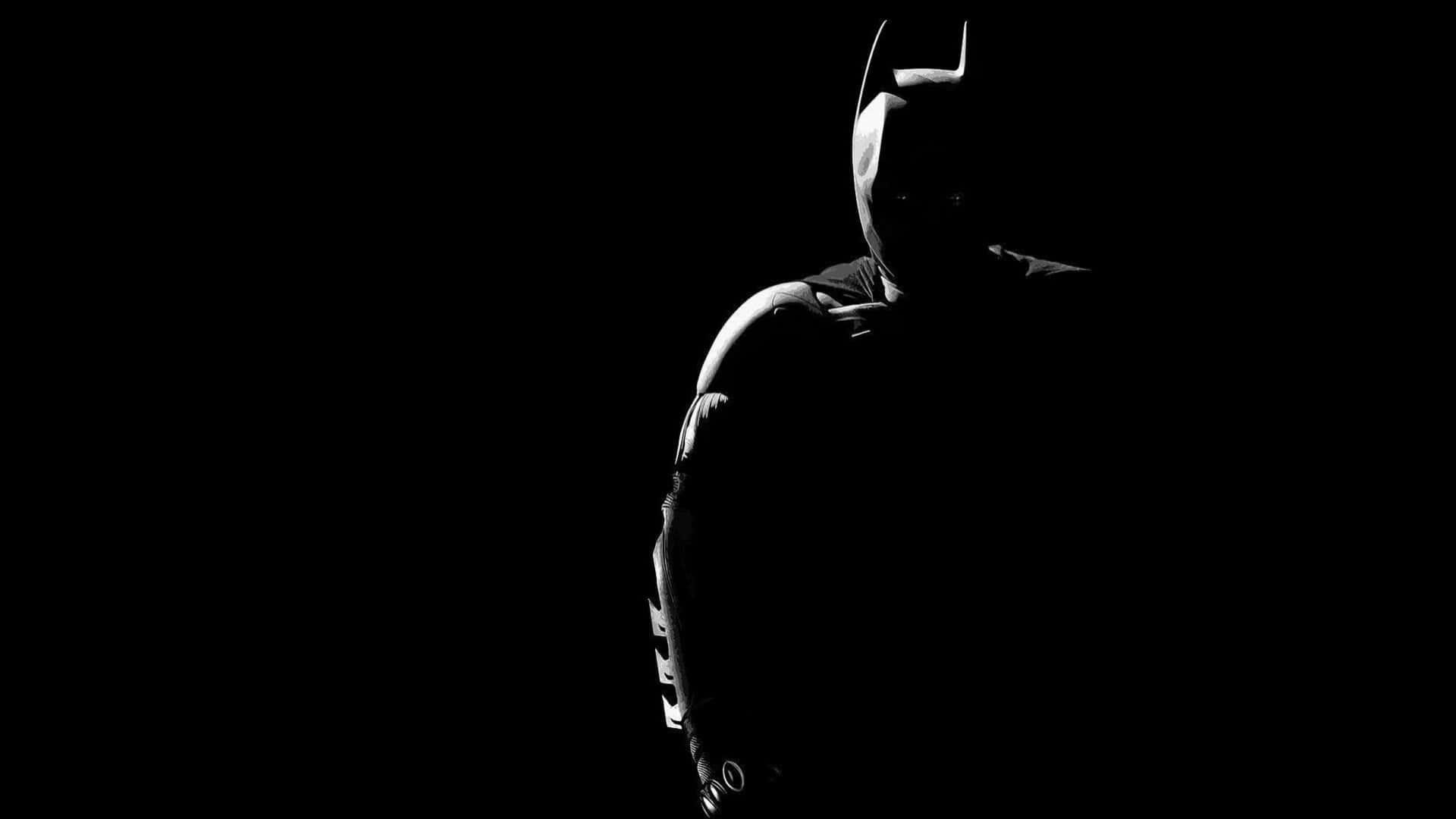 Batman In The Dark Silhouetted Against A Black Background