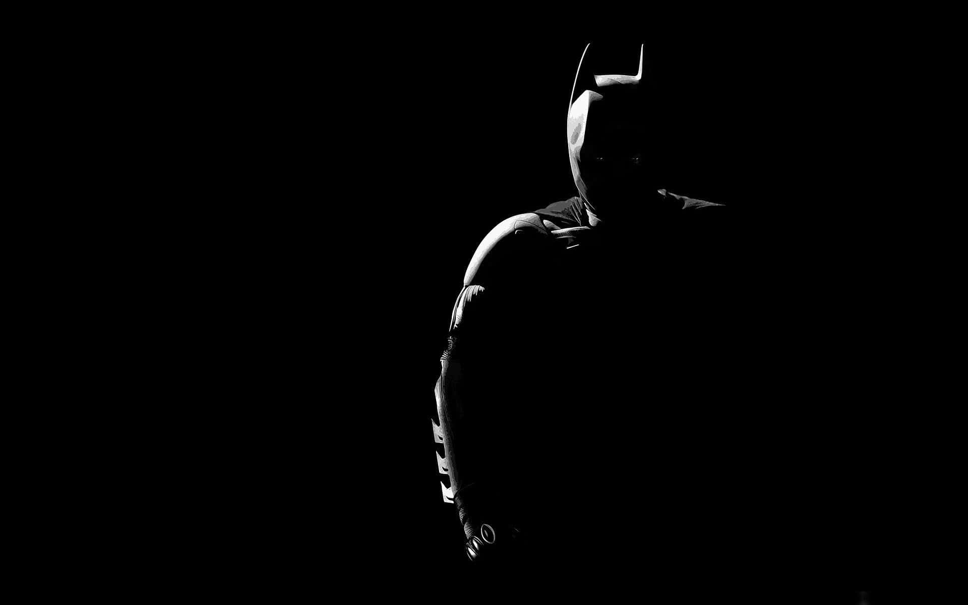 Batman In The Dark Silhouetted Against A Black Background Background
