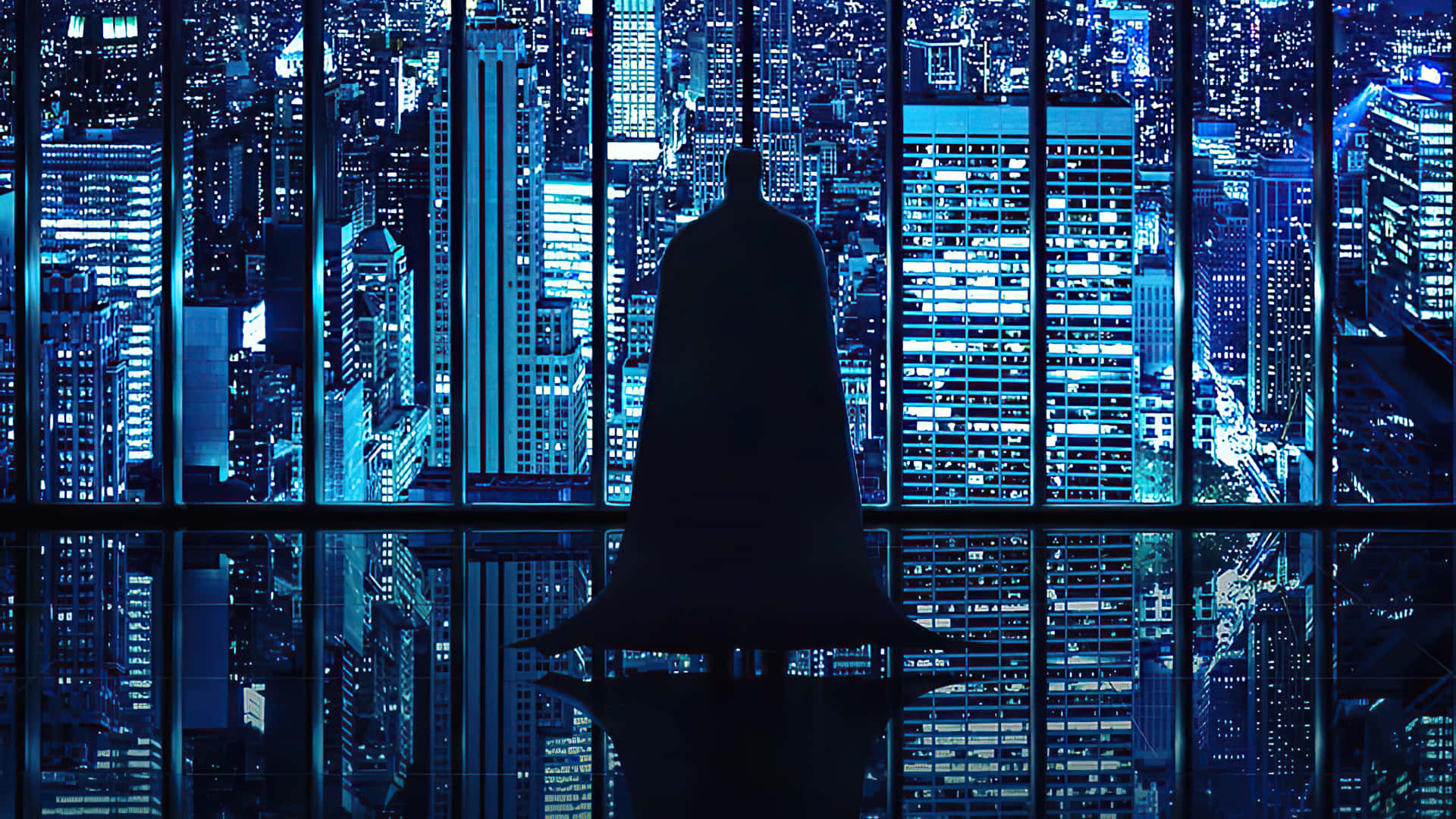Batman Standing In Front Of A City Background