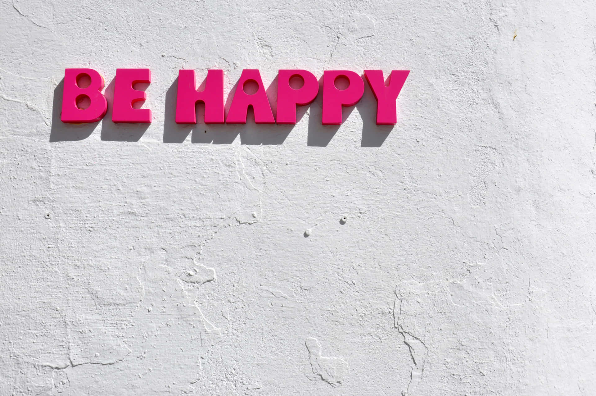 Be Happy Sign On A White Wall Background