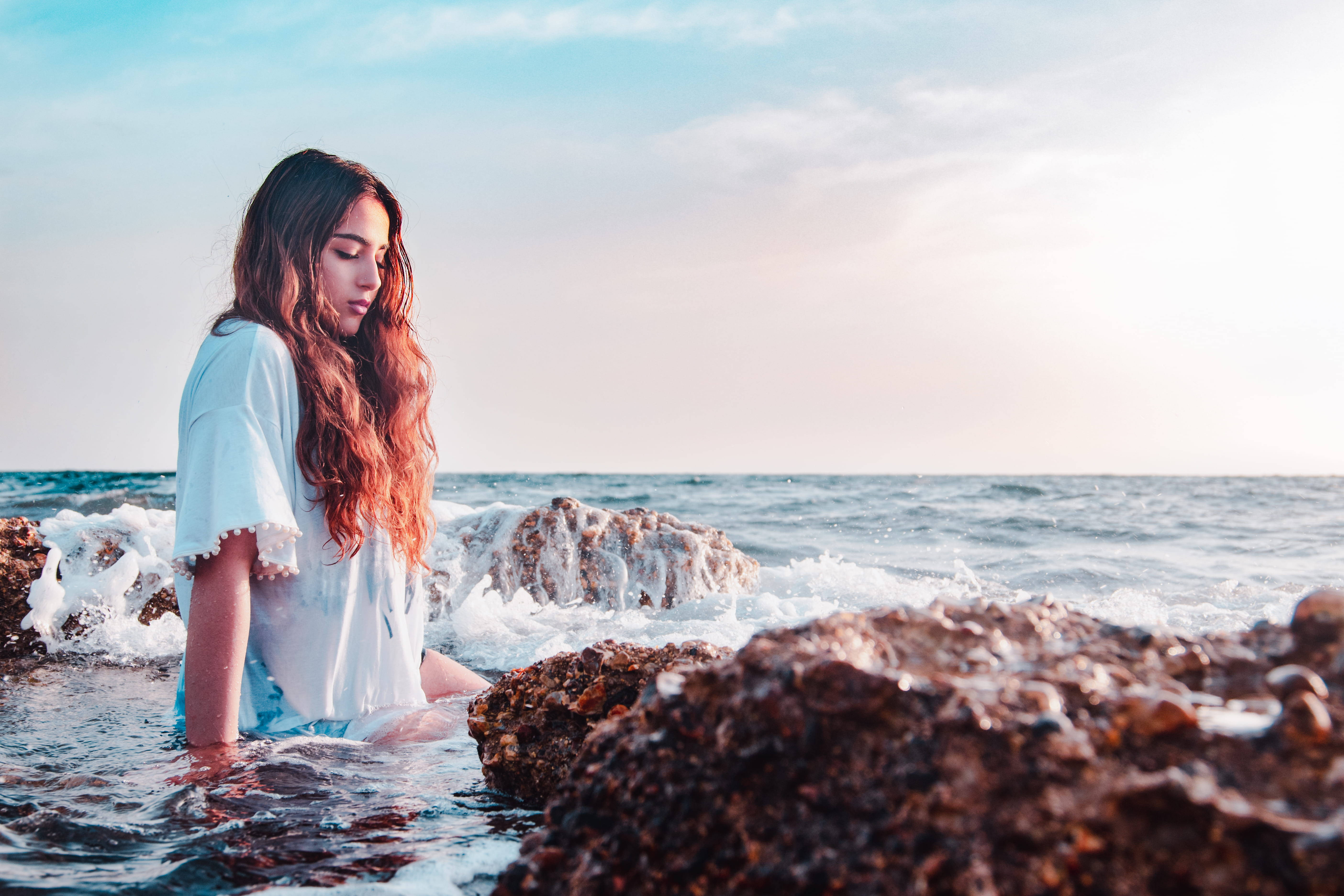 Beach Girl On Rocky Shore Background