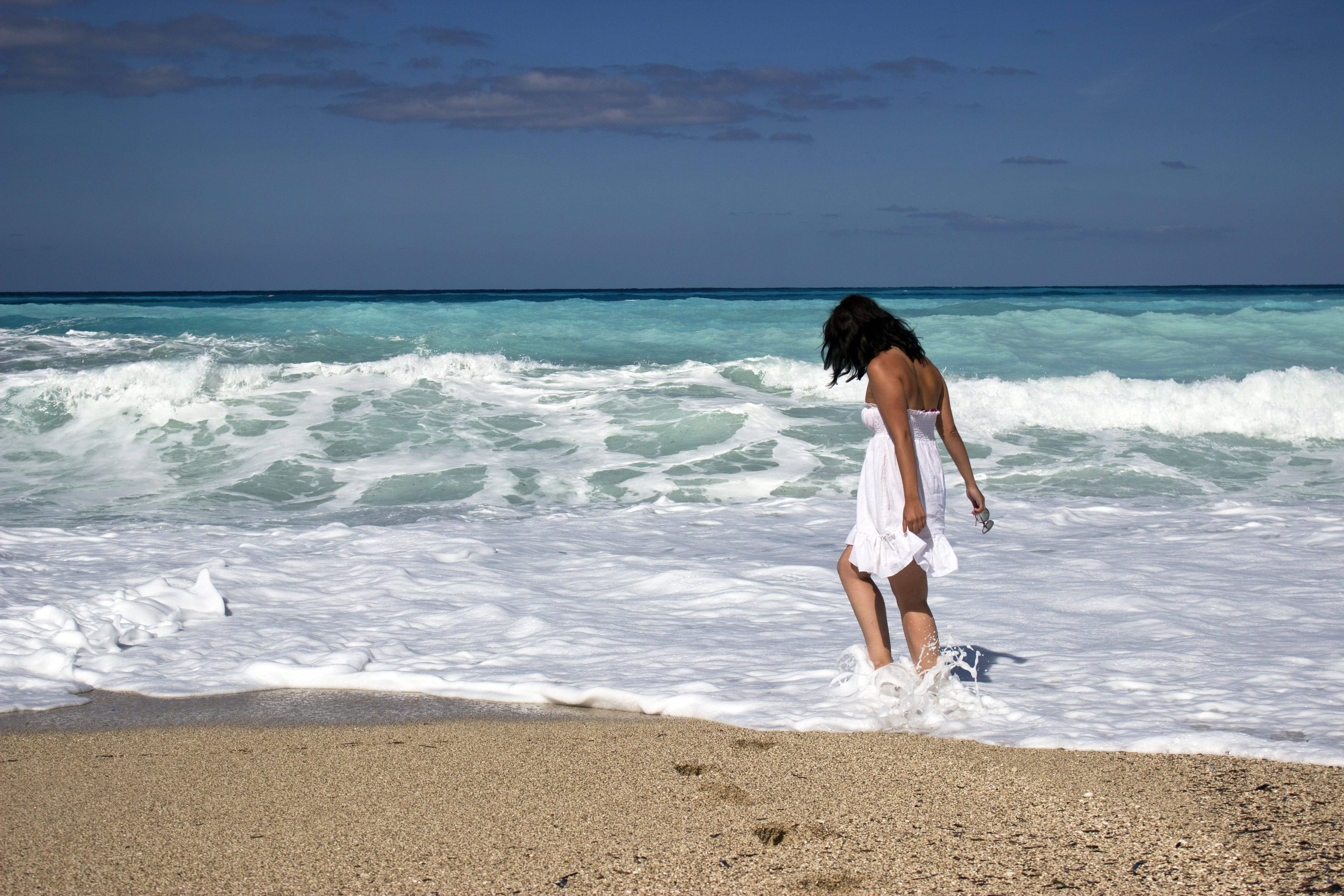 Beach Girl Walking Into Waves Background