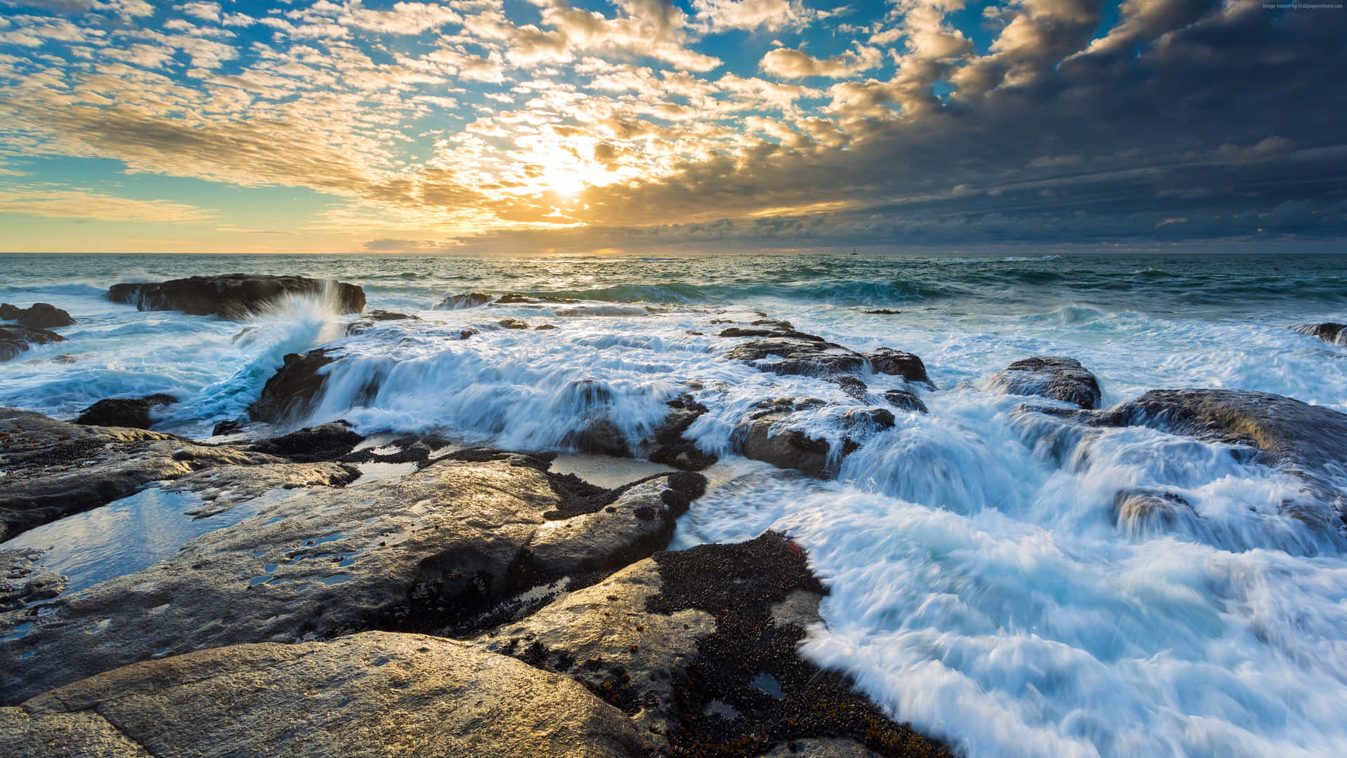 Beach Sunset Behind The Clouds Background