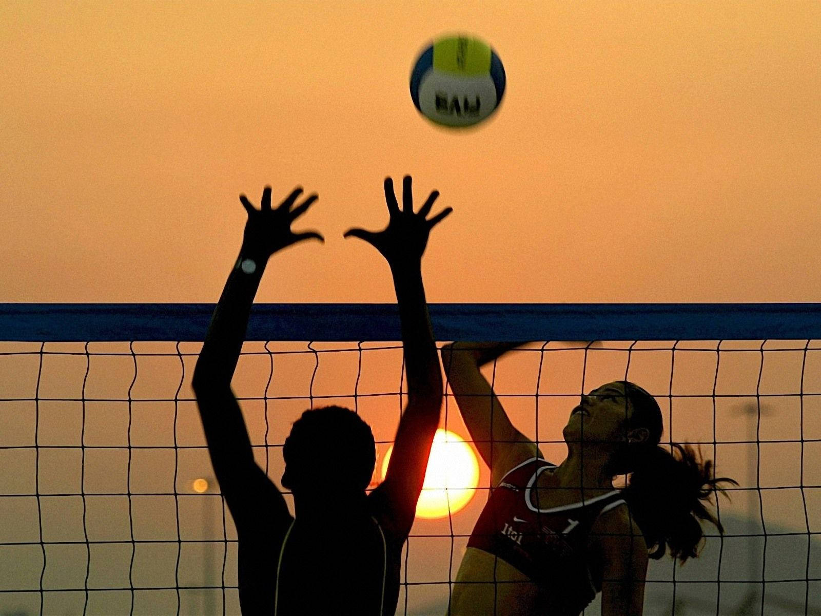 Beach Volleyball In Motion Blur At Sunset Background