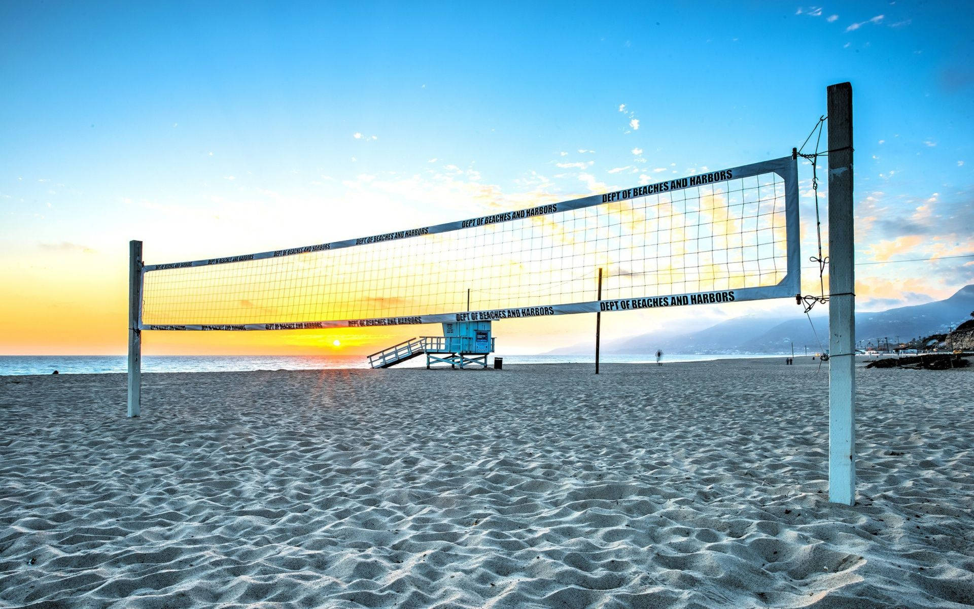 Beach Volleyball Net And Lifeguard Post Background