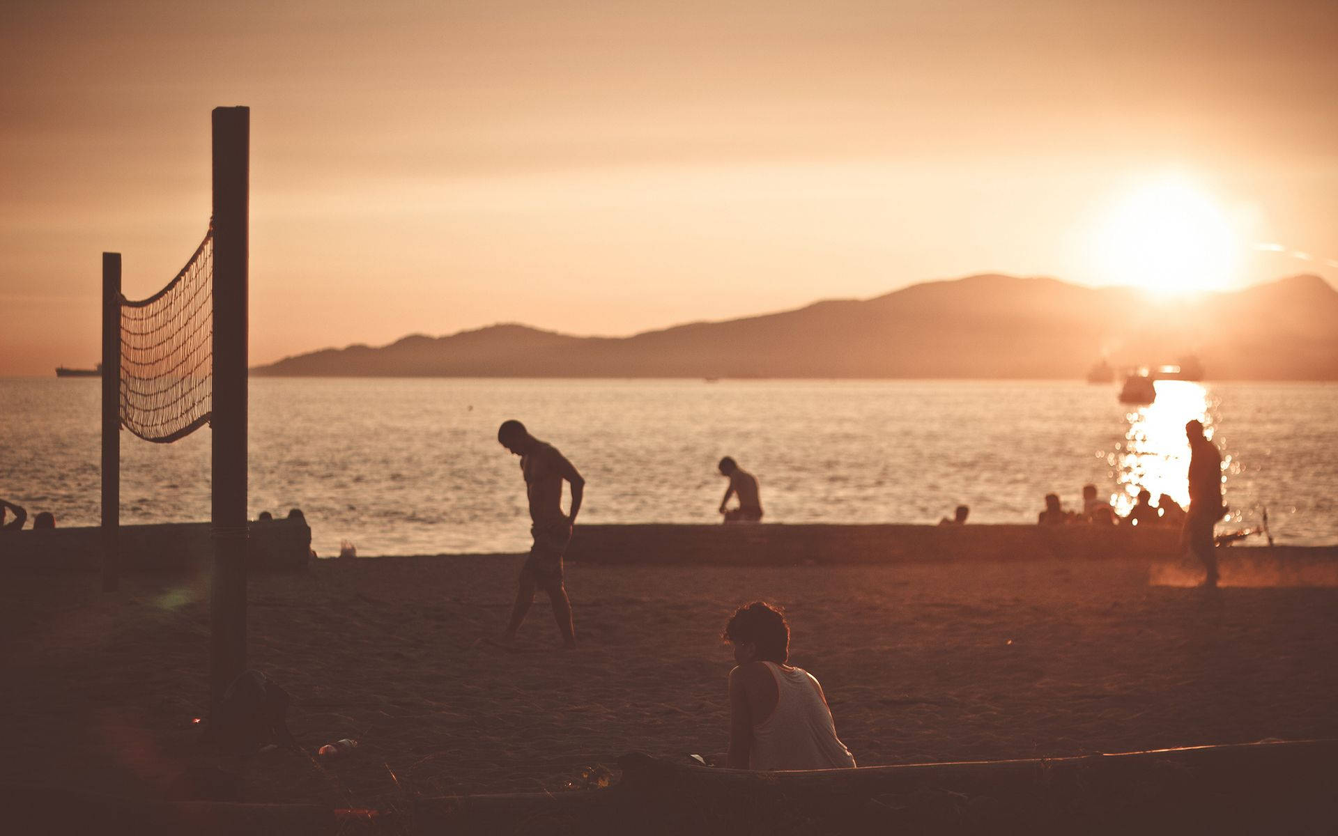 Beach Volleyball Net And Silhouette At Sunset Background