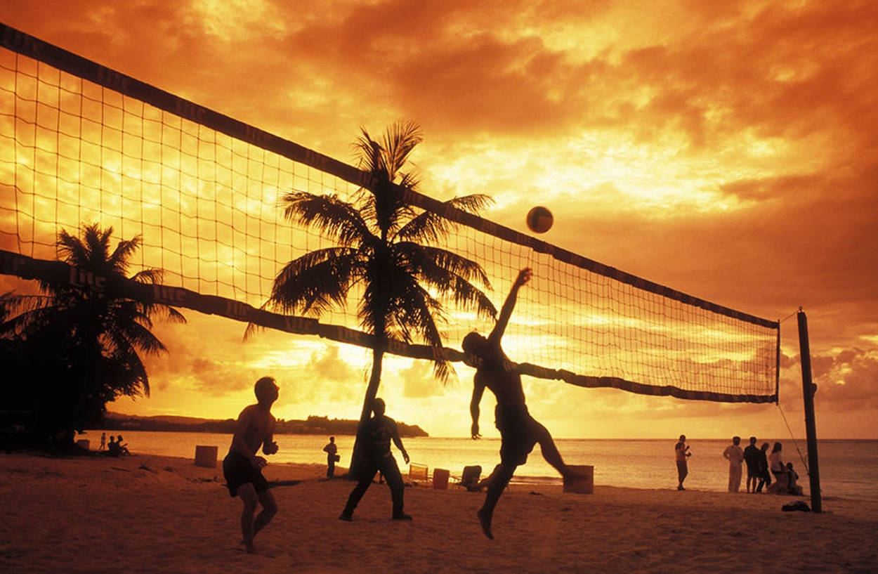 Beach Volleyball Silhouette And Orange Sky Background