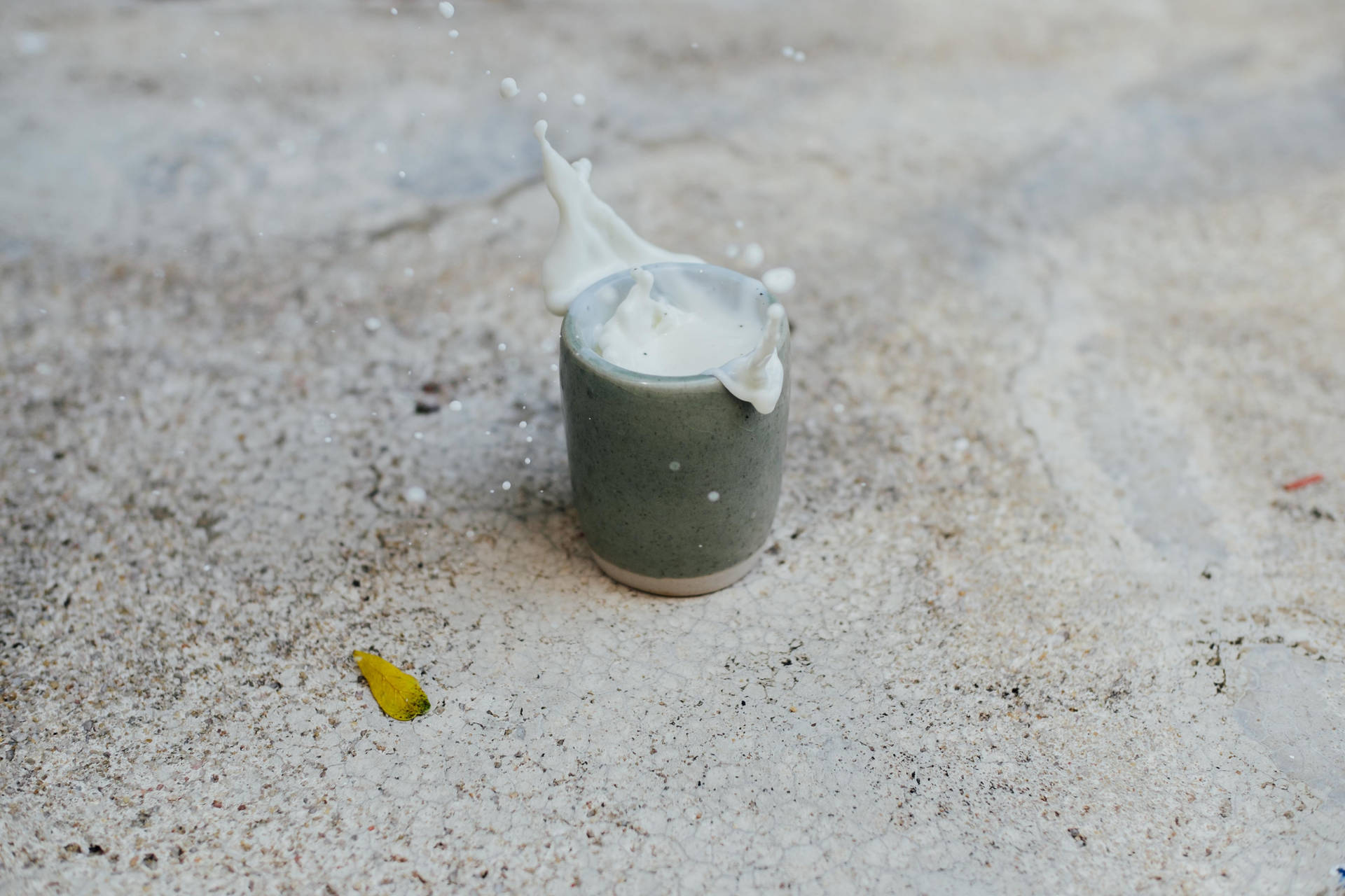 Beaker With Milk On Sand Background