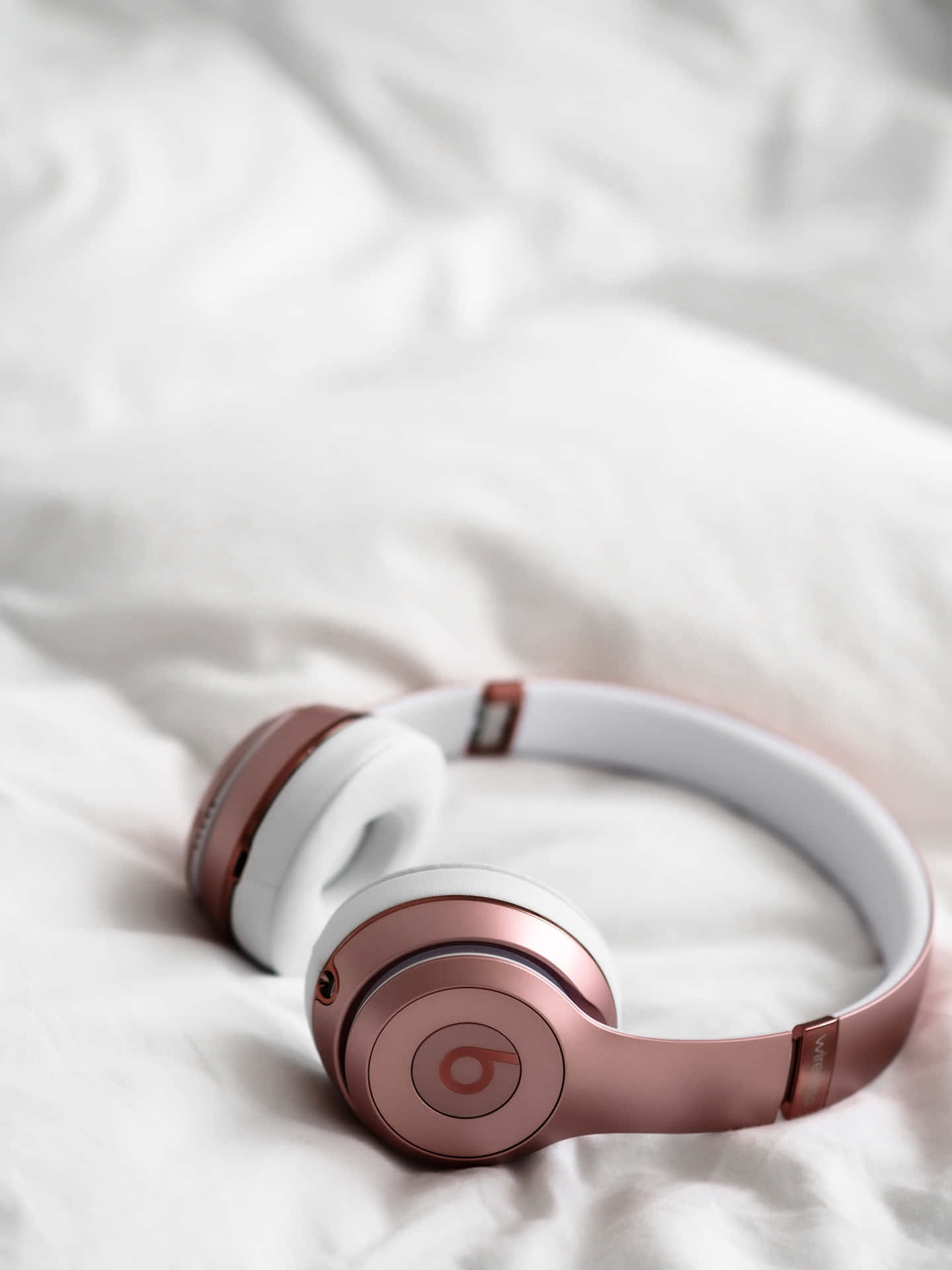 Beats Solo3 Headphones On A Bed Background