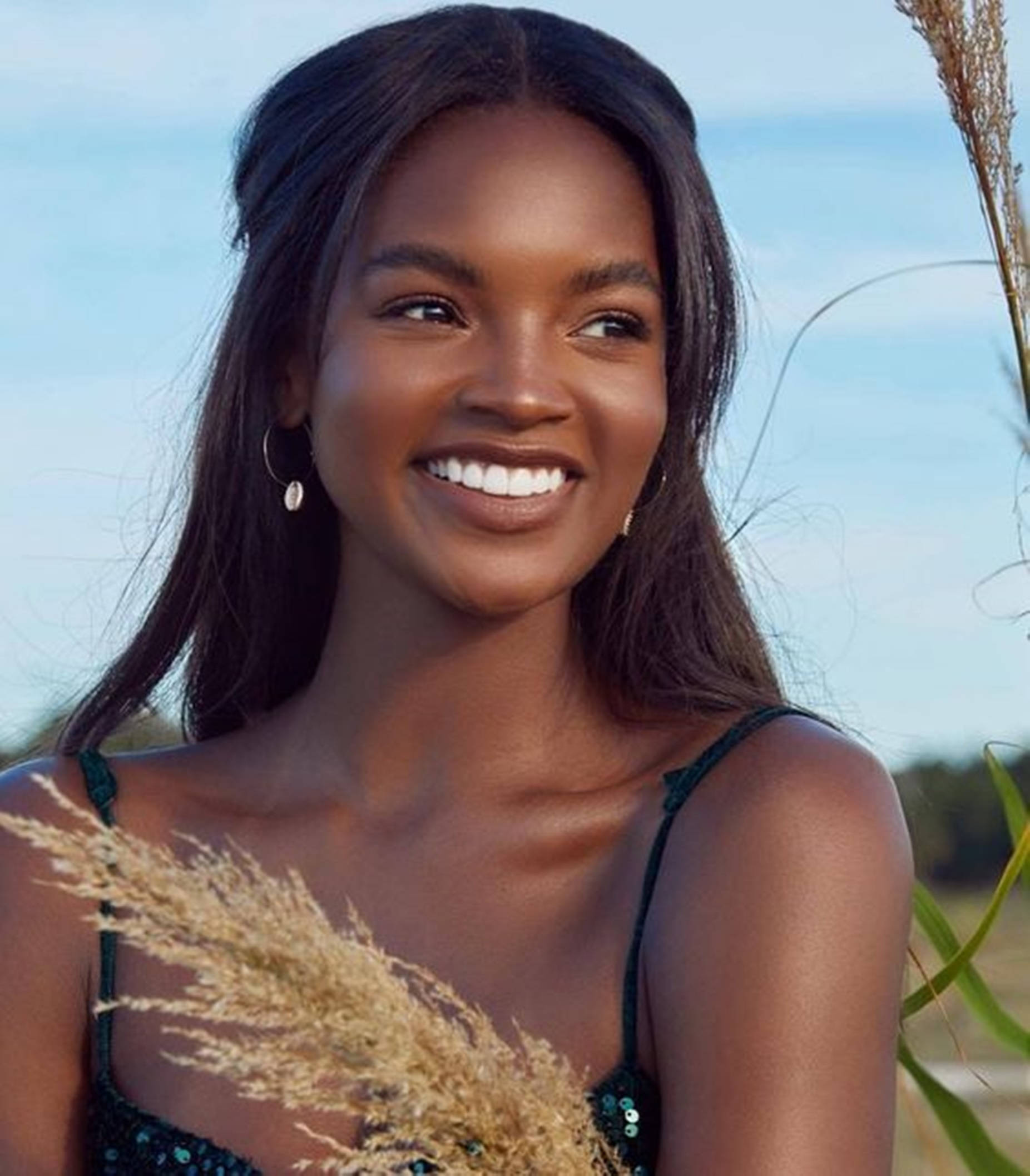 Beautiful Black Woman Posing With A Sprig Of Wheat Background