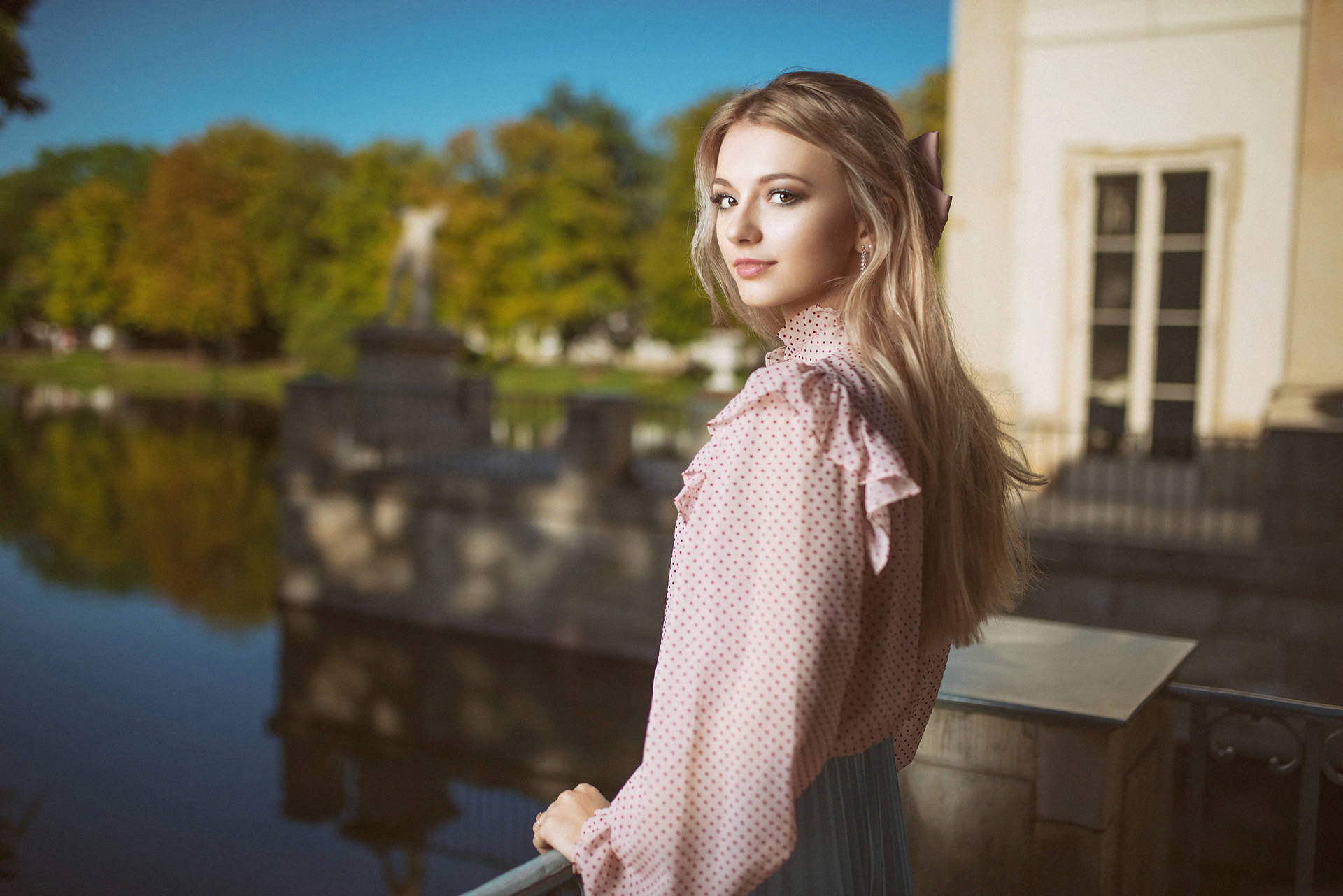 Beautiful Blonde Wearing A Pink Blouse Background