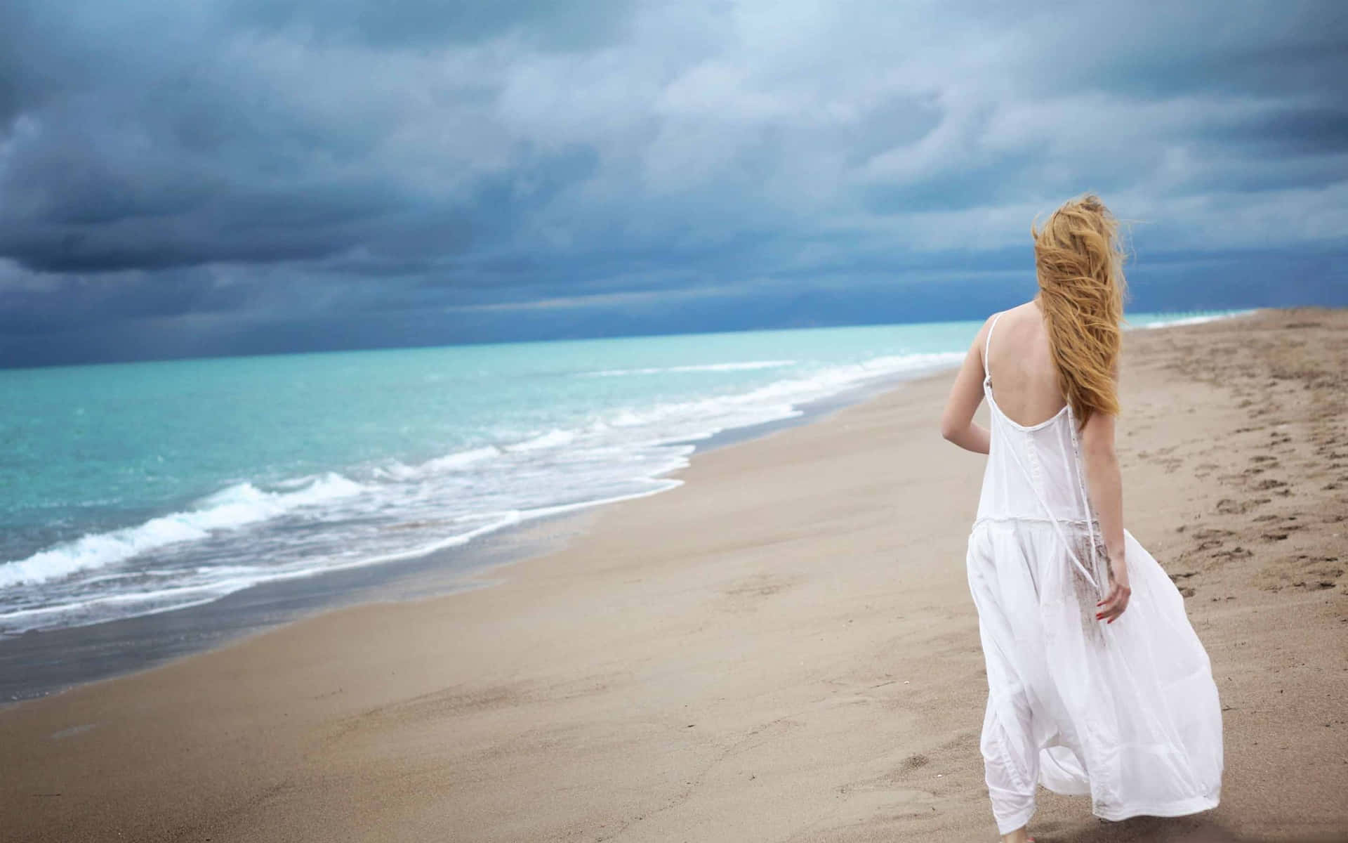 Beautiful Girl On Beach Wearing White Gown