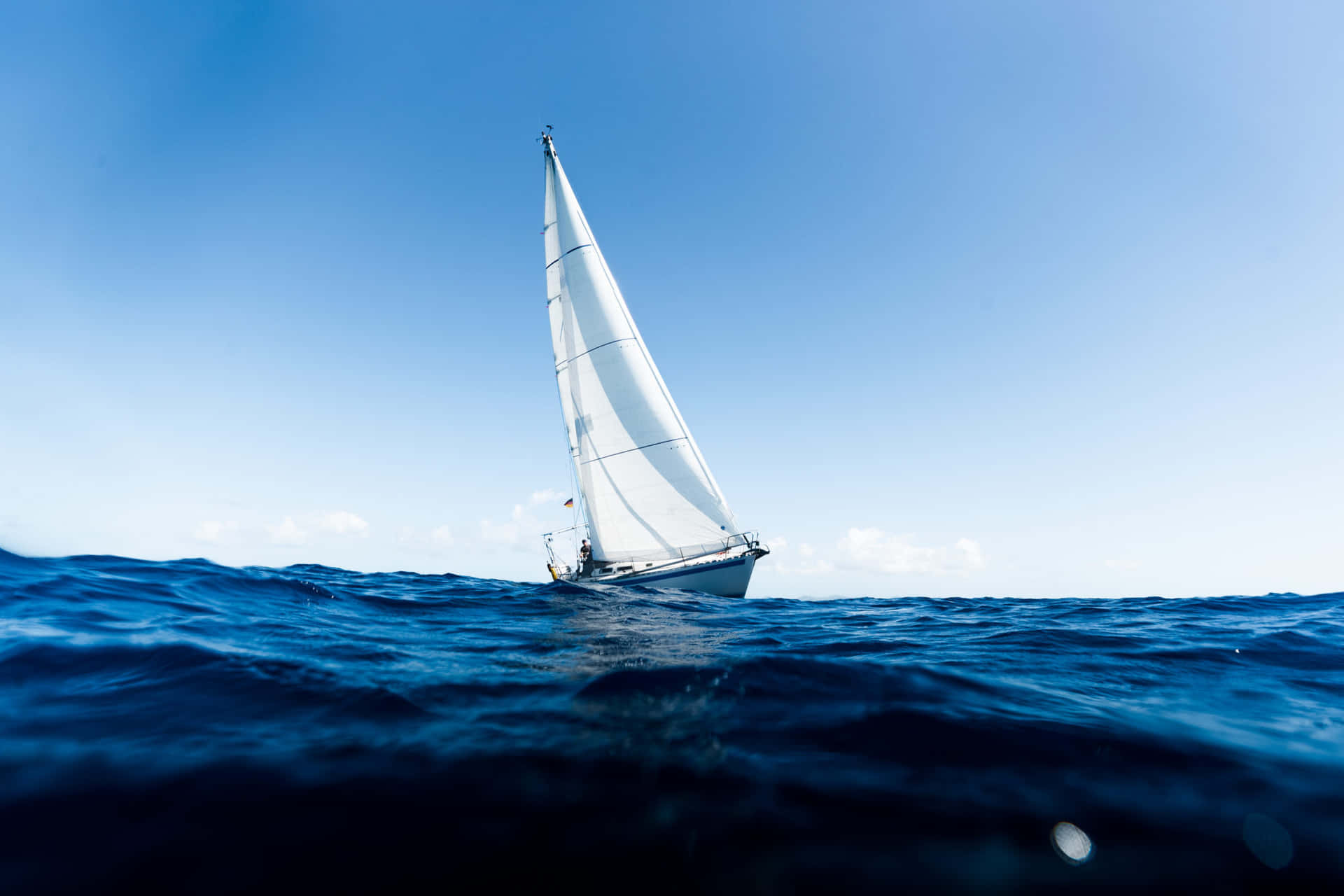 Beautiful Lone Sailboat At Sunset Background