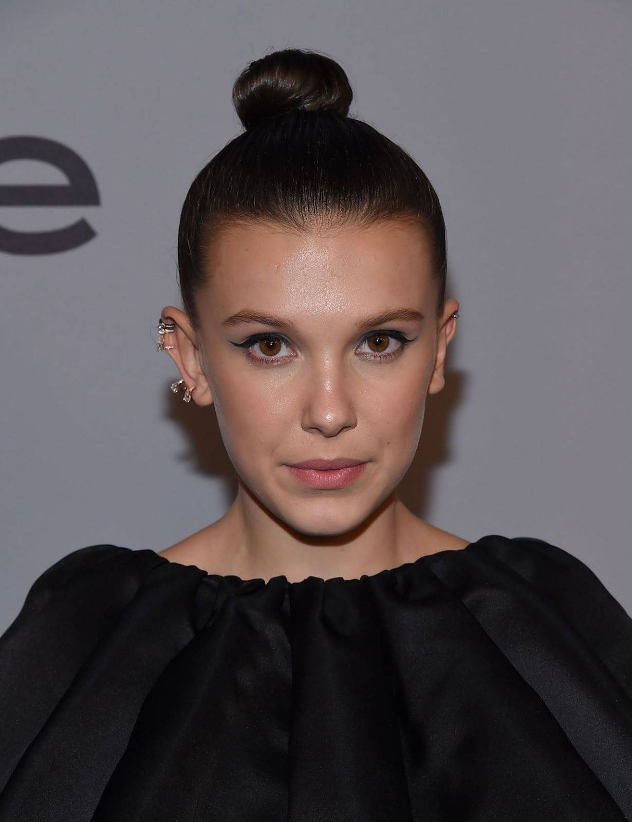 Beautiful Millie Bobby Brown In Black Dress Background