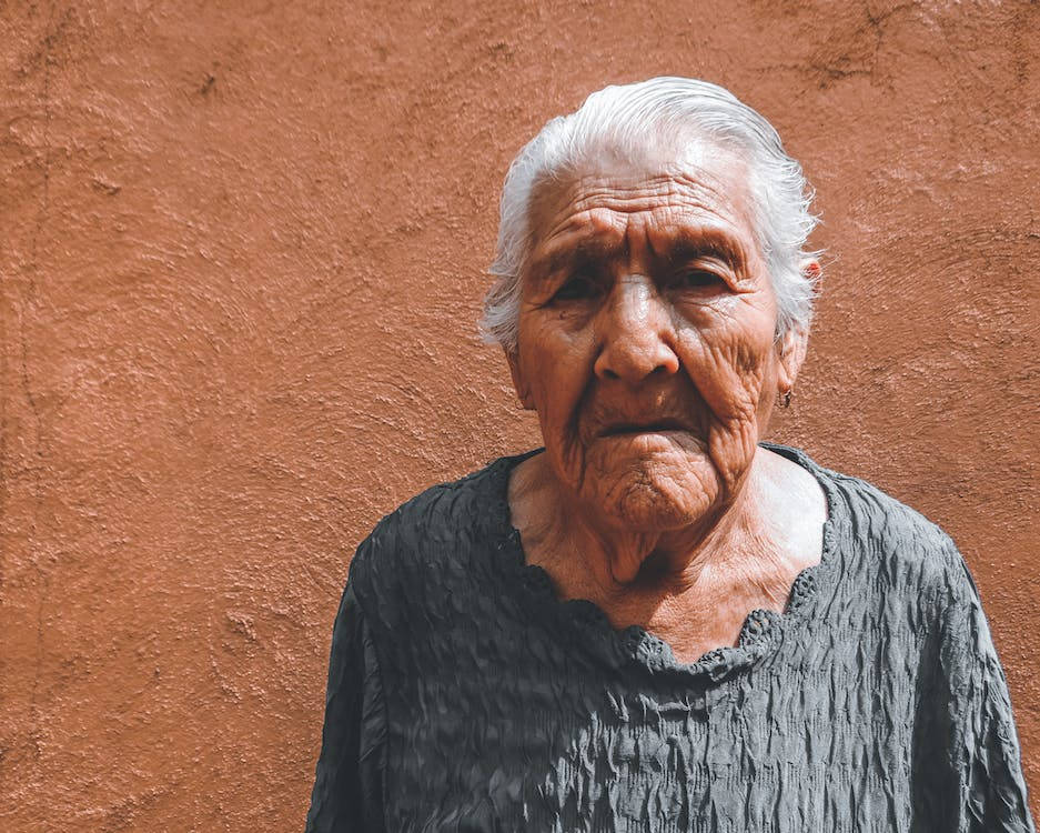 Beautiful Older Woman On Brown Background