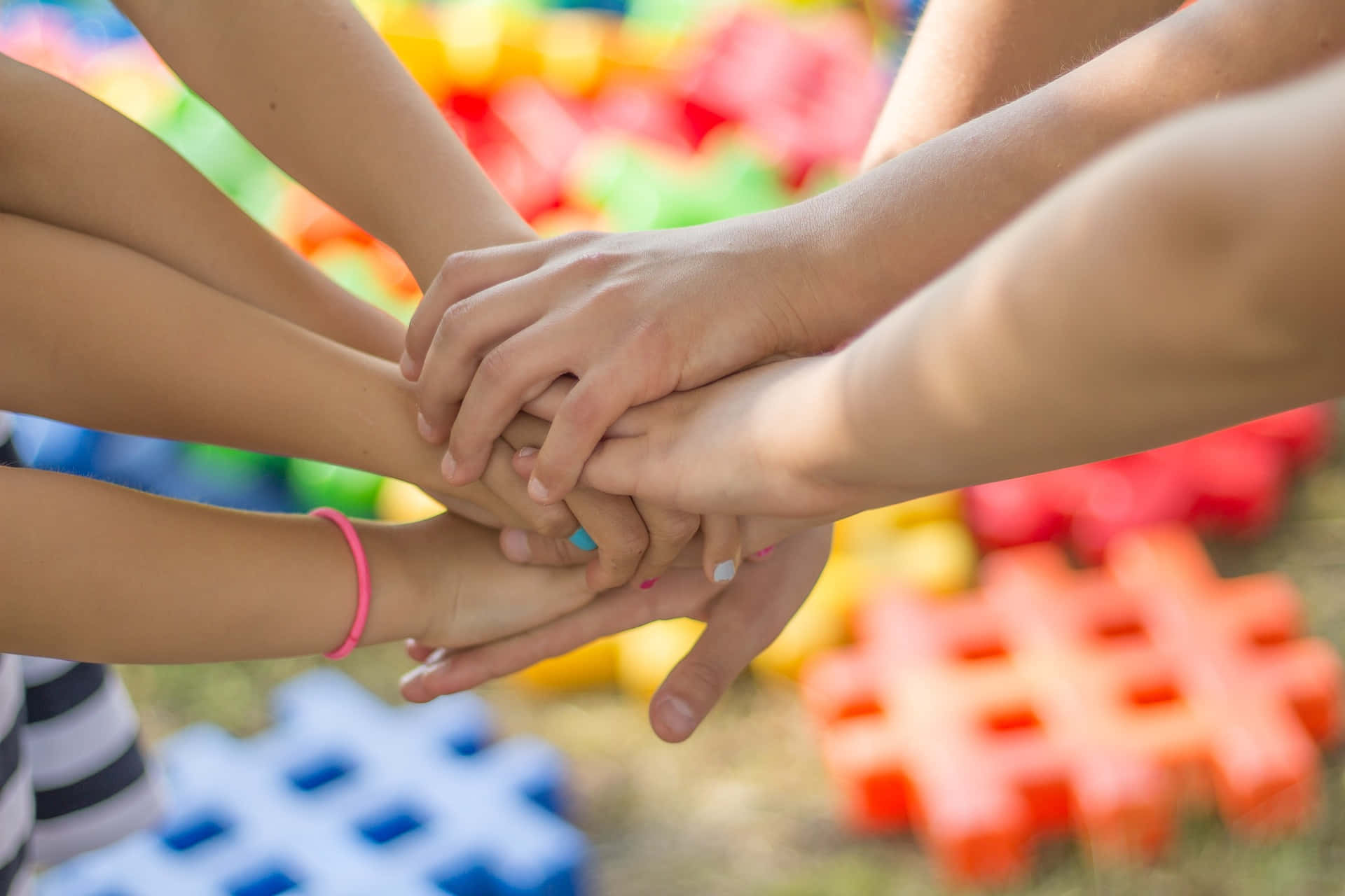 Beautiful Shot Of Children Friends Put Their Tangible Hands Together Background