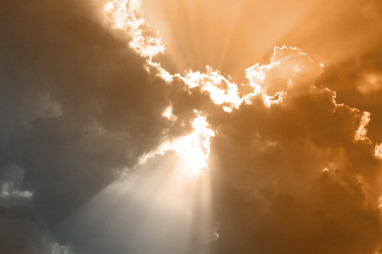 Beautiful Sun Rays On Funeral Clouds Background