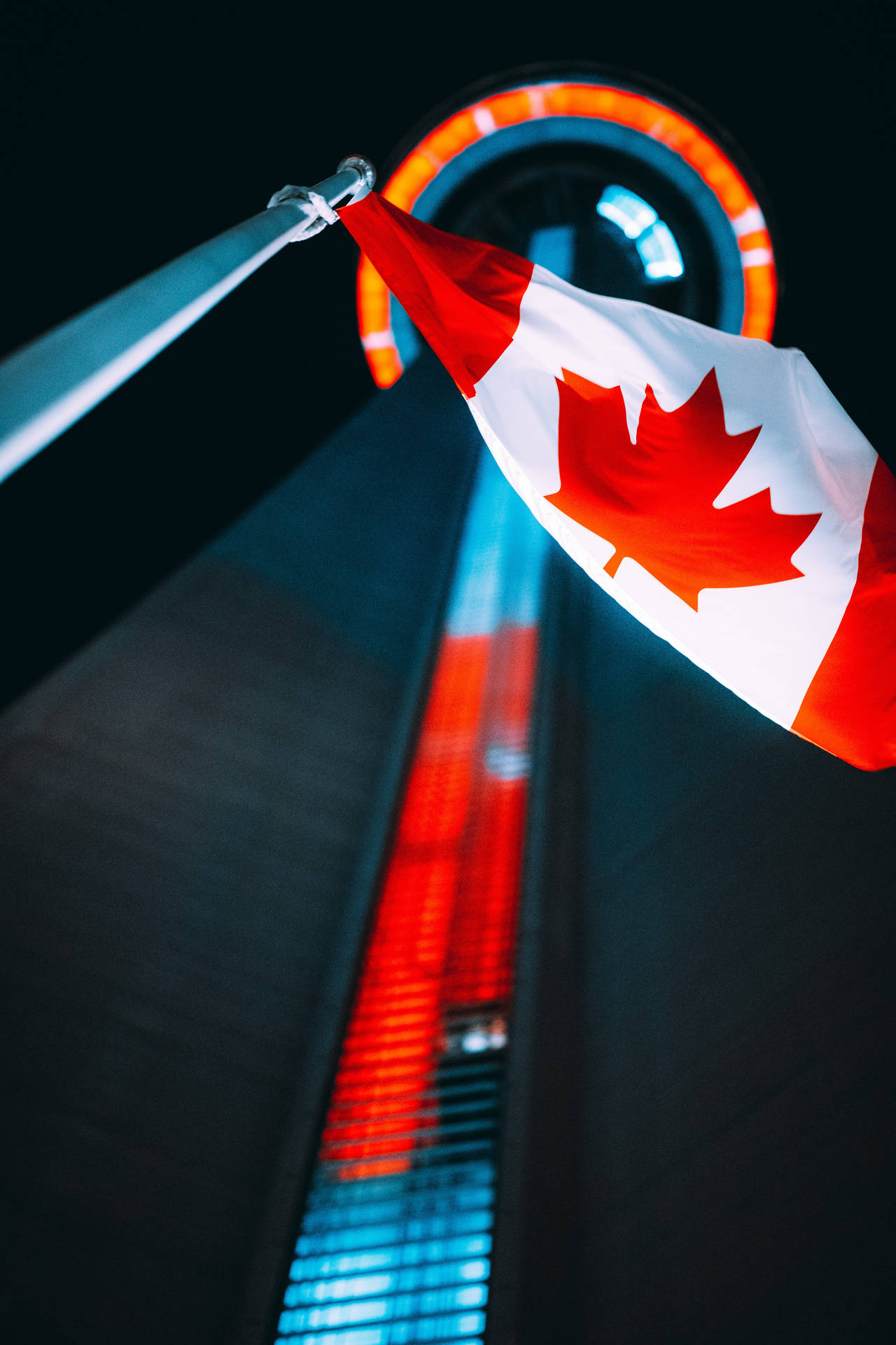 Beautiful View Of The Cn Tower With Canadian Flag Waving Proudly Background