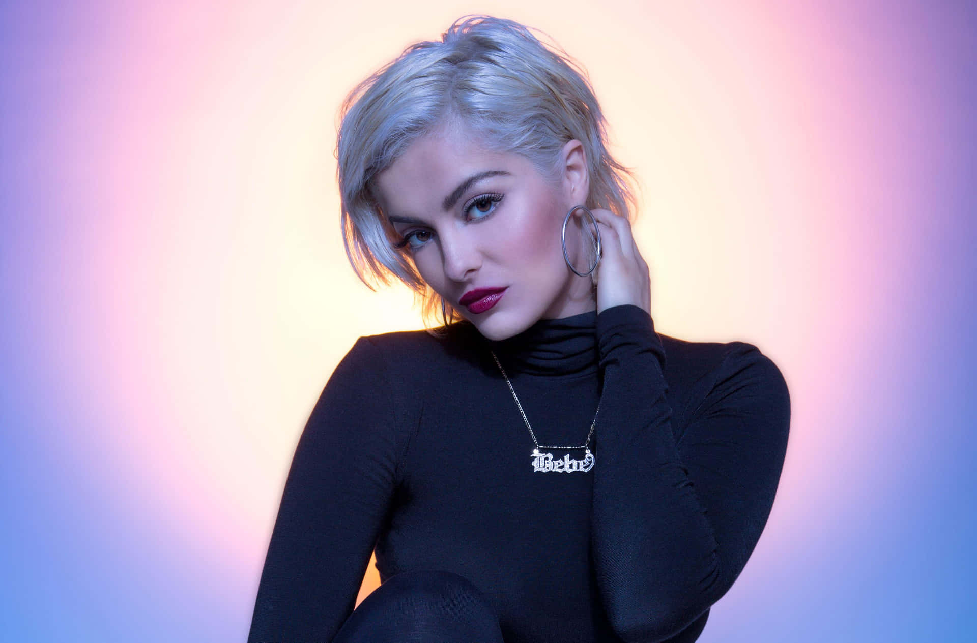 Bebe Rexha Striking A Pose On Stage Background