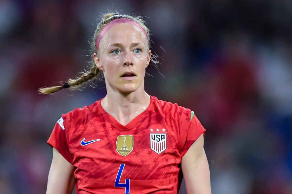 Becky Sauerbrunn In Action During A Soccer Match. Background