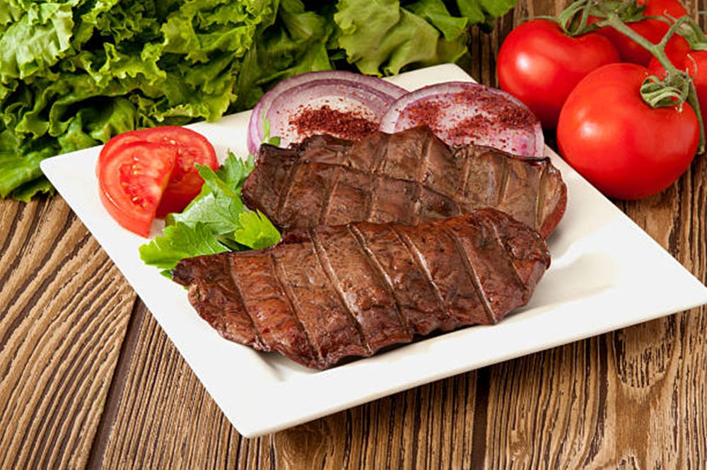 Beef Liver Slices On A Square Platter Background