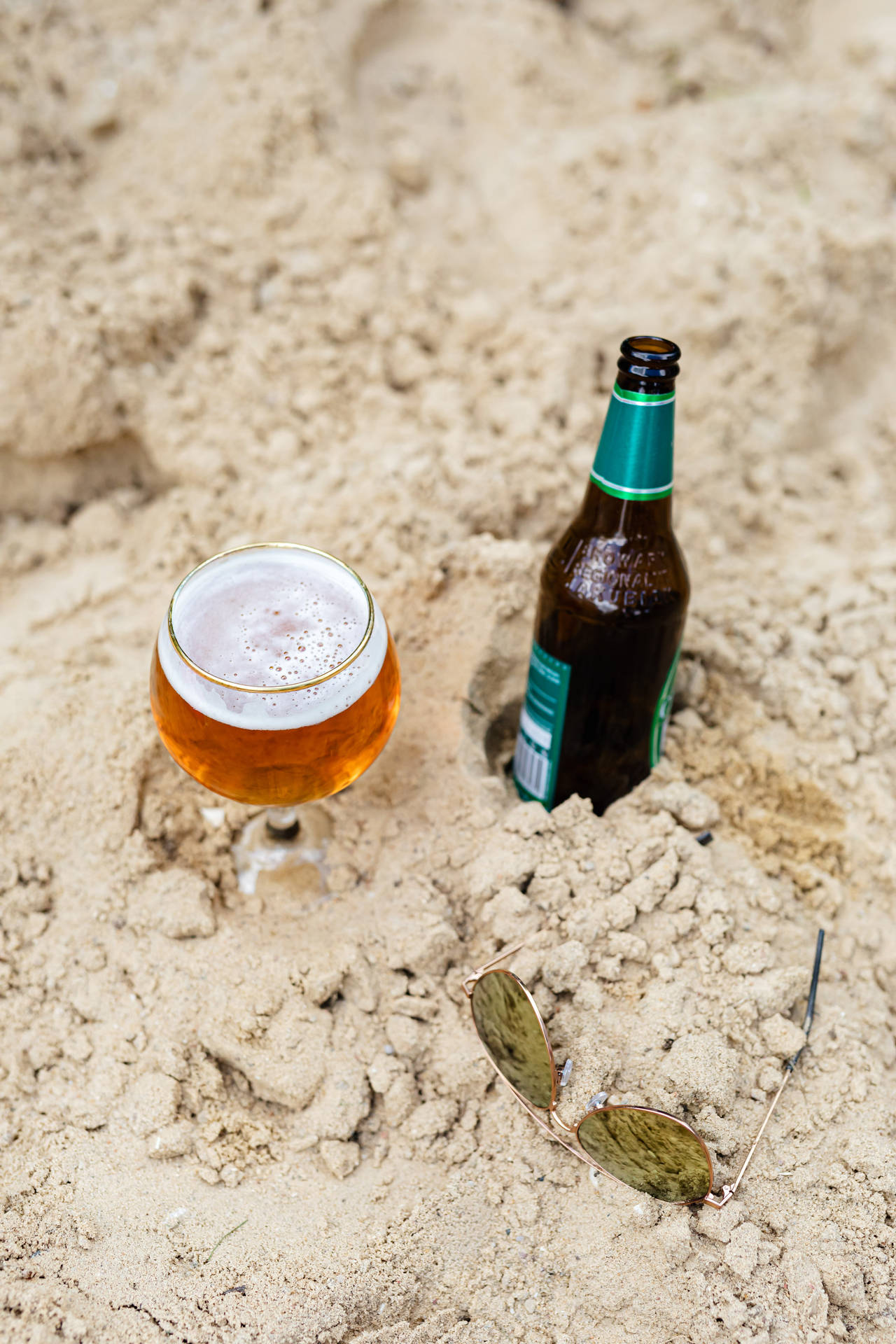 Beer Bottle Buried In The Sand Background