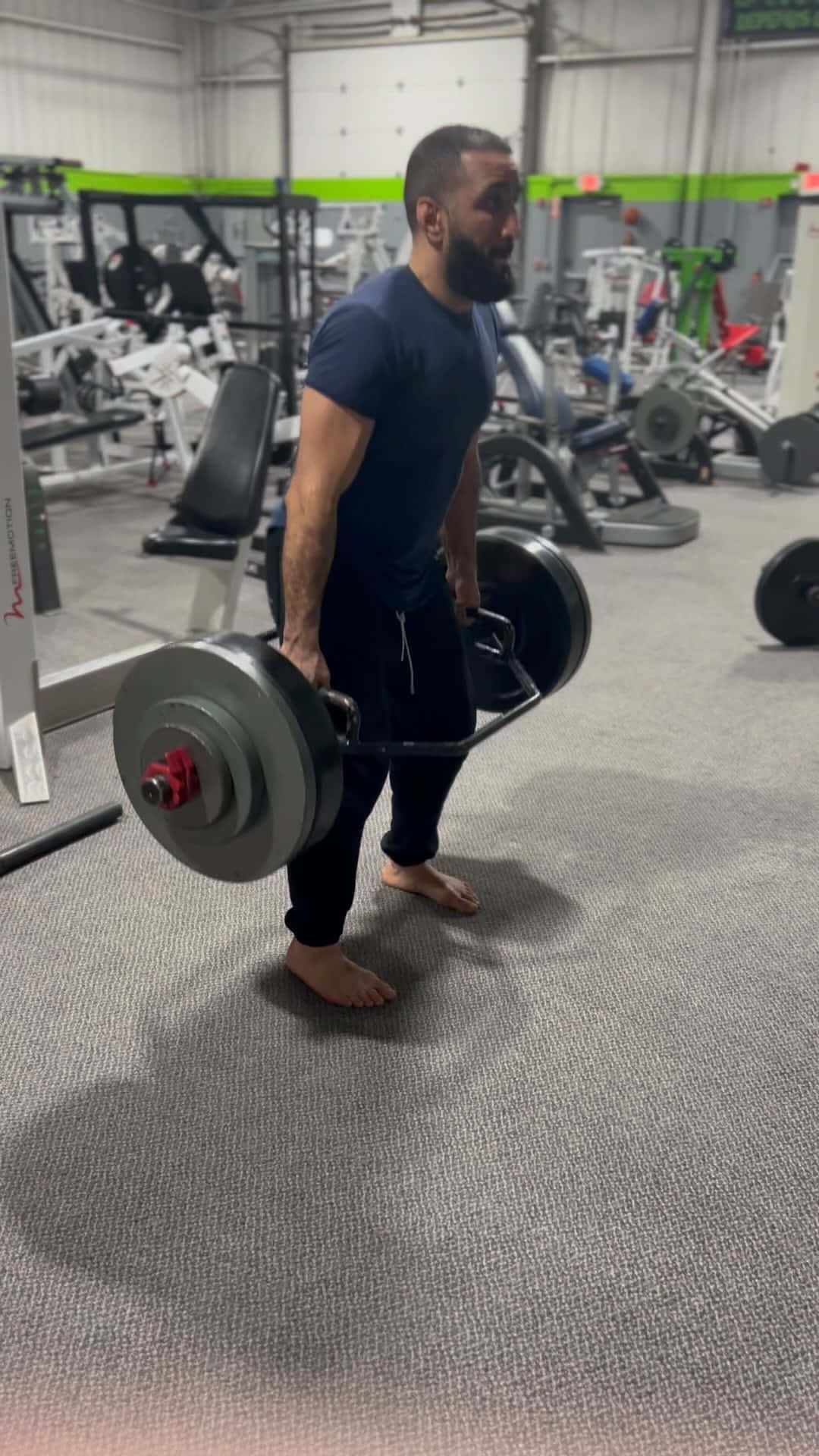 Belal Muhammad Lifting Weights At The Gym Background