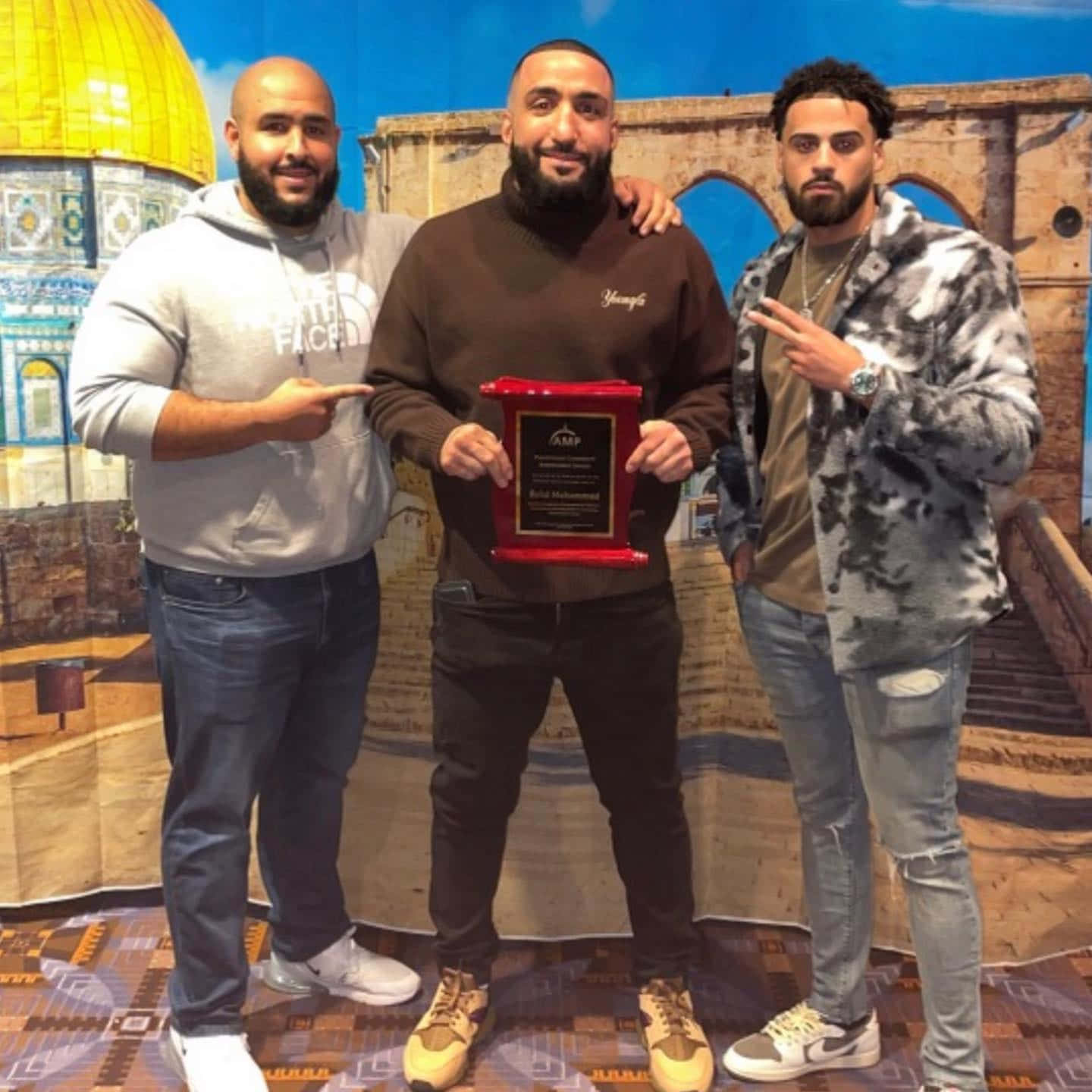 Belal Muhammad Posing With His Friends Background