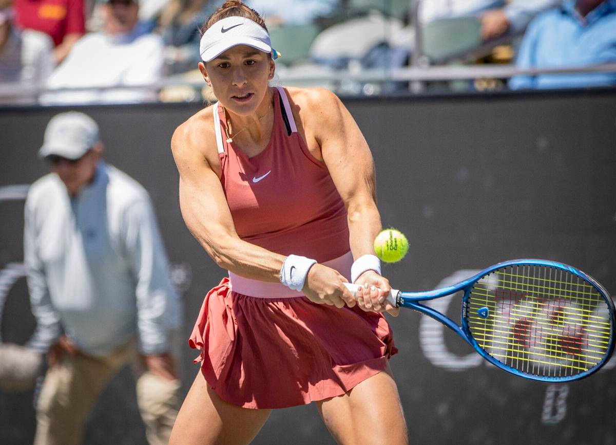 Belinda Bencic Showcasing Her Strength In A Professional Tennis Match Background