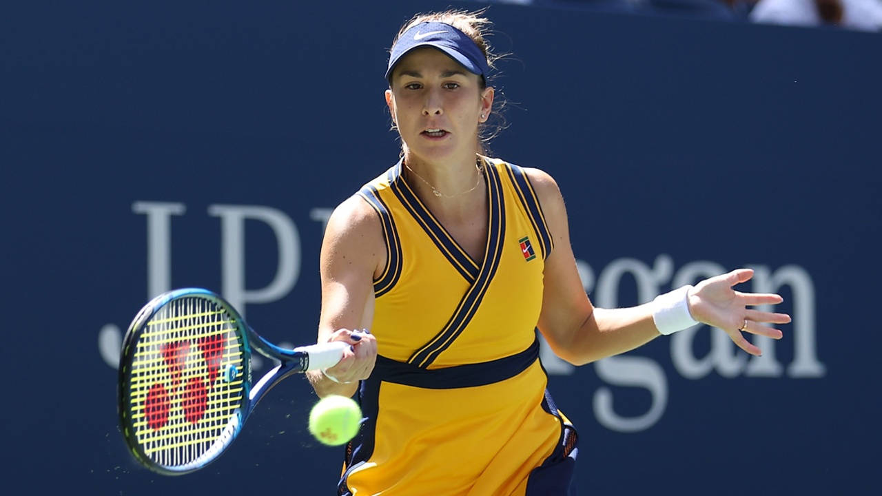 Belinda Bencic Skillfully Receives A Tennis Ball During A Match. Background