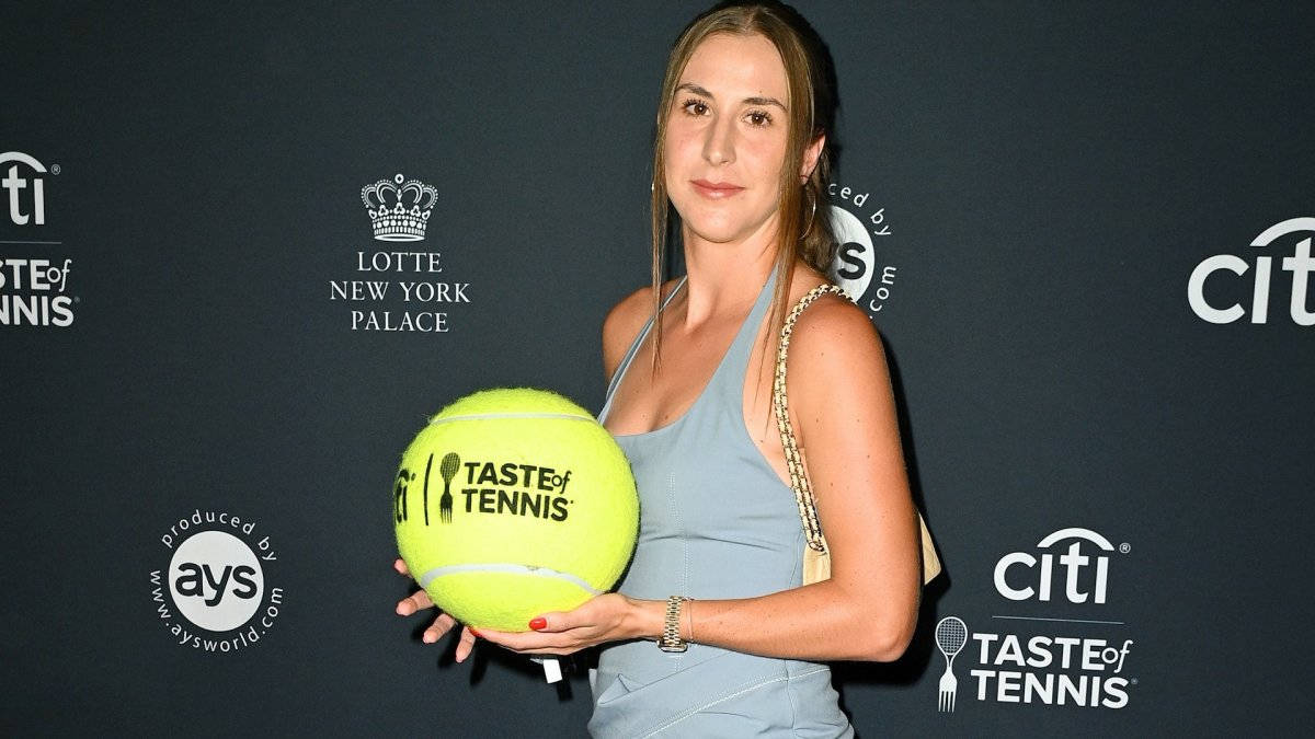 Belinda Bencic With Large Tennis Ball Background