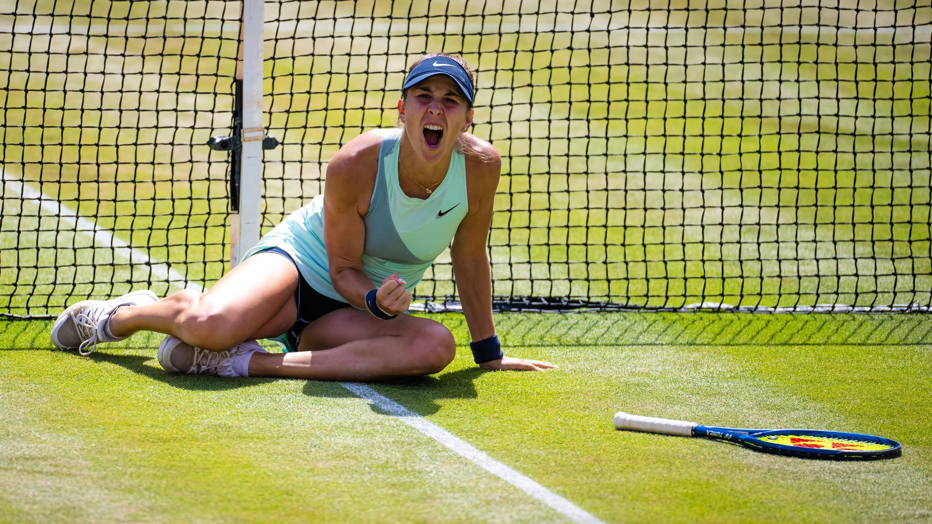 Belinda Bencic Yelling On Grassy Court Background