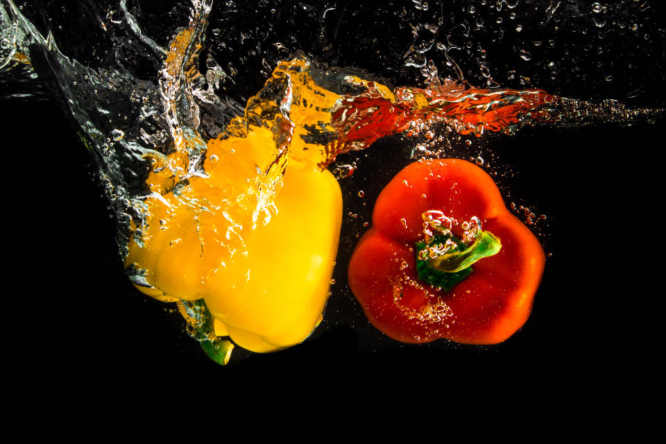 Bell Pepper Fruits Splashing Into Water Background
