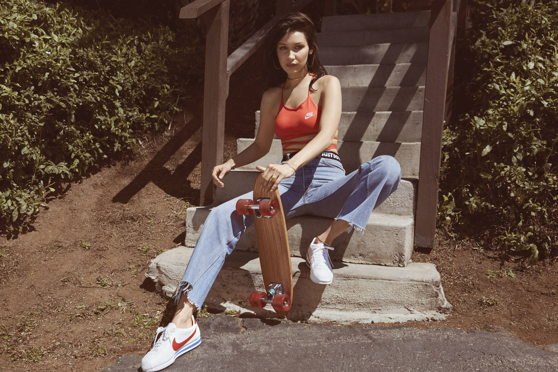 Bella Hadid Sitting With Skateboard Background