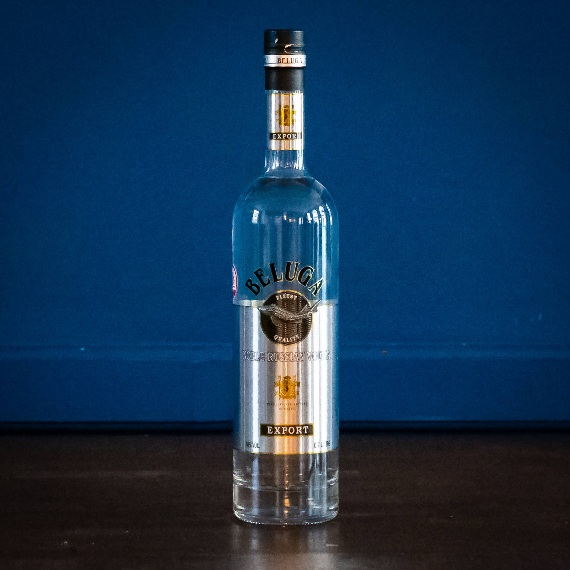 Beluga Vodka Glass Bottle On Blue Backdrop Background