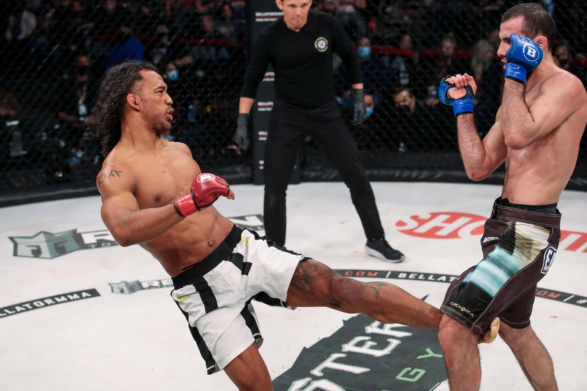 Ben Henderson Executing A High Inside Kick Against Islam Mamedov In An Mma Match Background