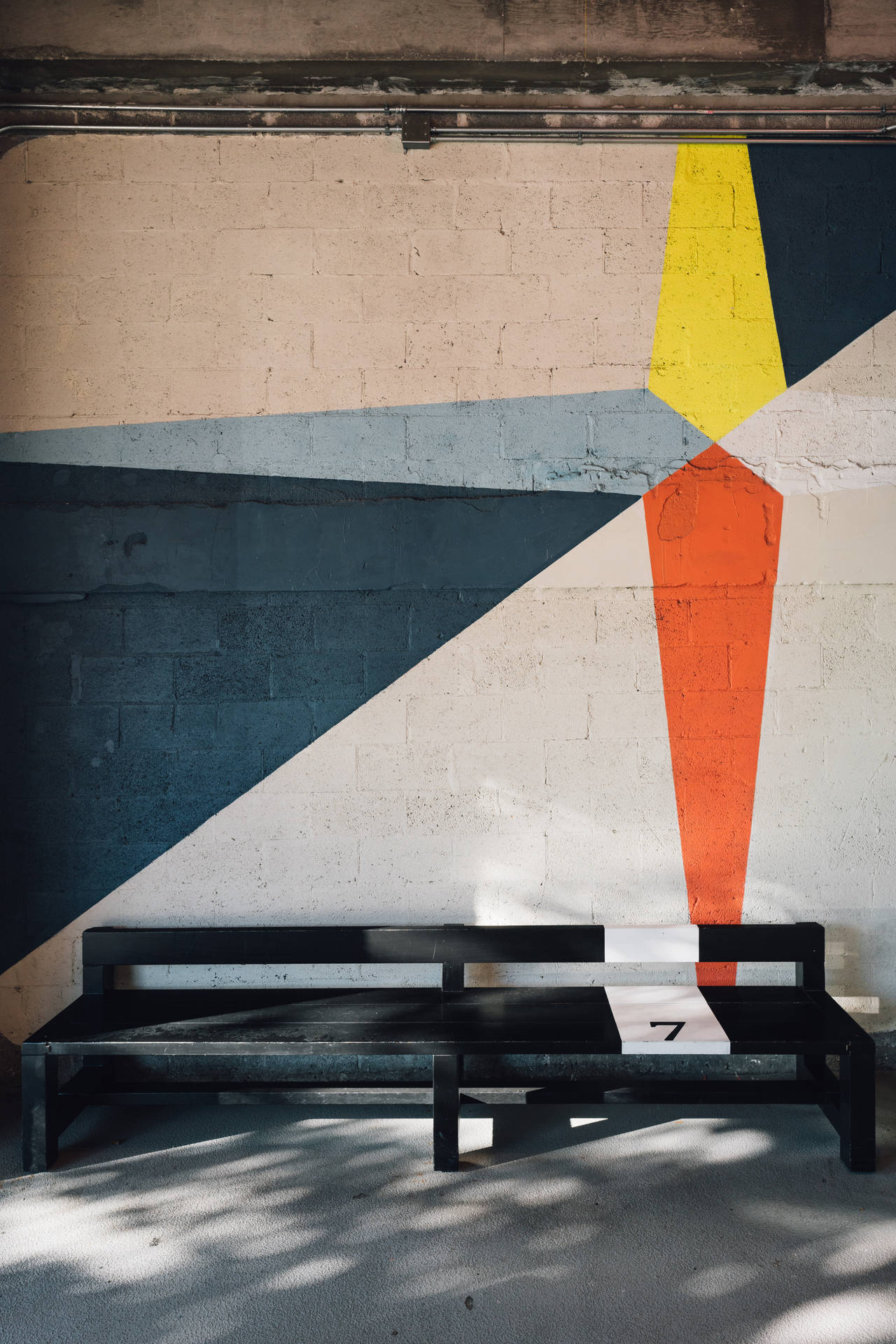 Bench Against Geometric Wall Background