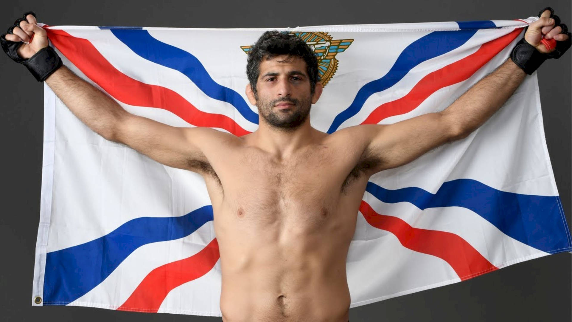 Beneil Dariush Holding Assyrian Flag Background