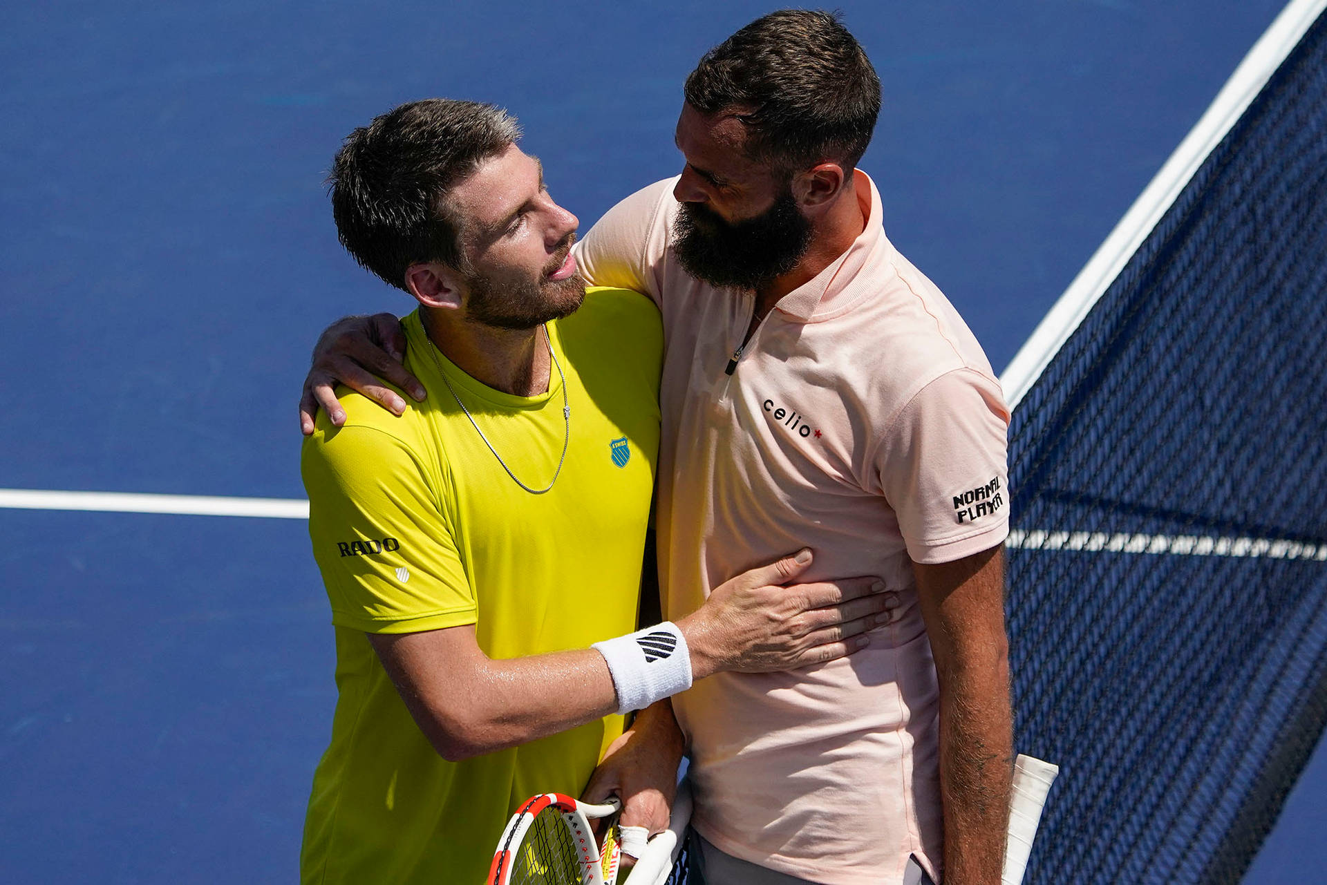 Benoit Paire And Cameron Norrie Sharing An Embrace After A Tennis Match. Background