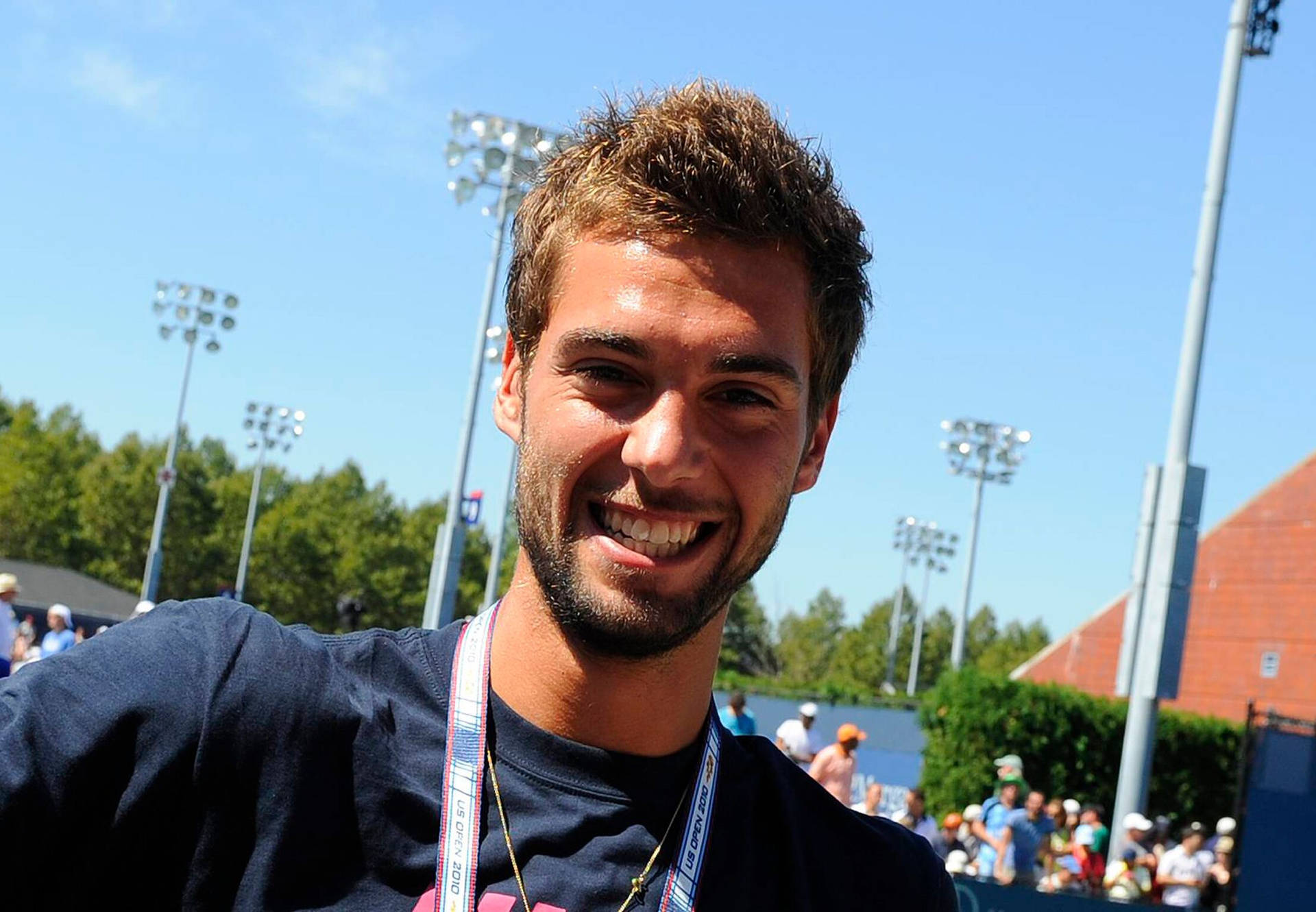 Benoit Paire Smiling Brimming With Confidence Background