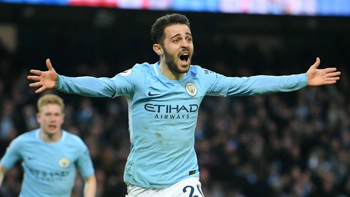 Bernardo Silva Raising Arms In A Challenge Background